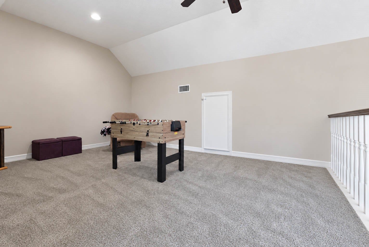 33103 Whickham Circle, Fulshear, TX 77441 A second perspective highlights the impressive width and flexibility of the upstairs game room. Neutral finishes and an open layout provide an adaptable backdrop for billiards, media, recreation, or additional lounge space.