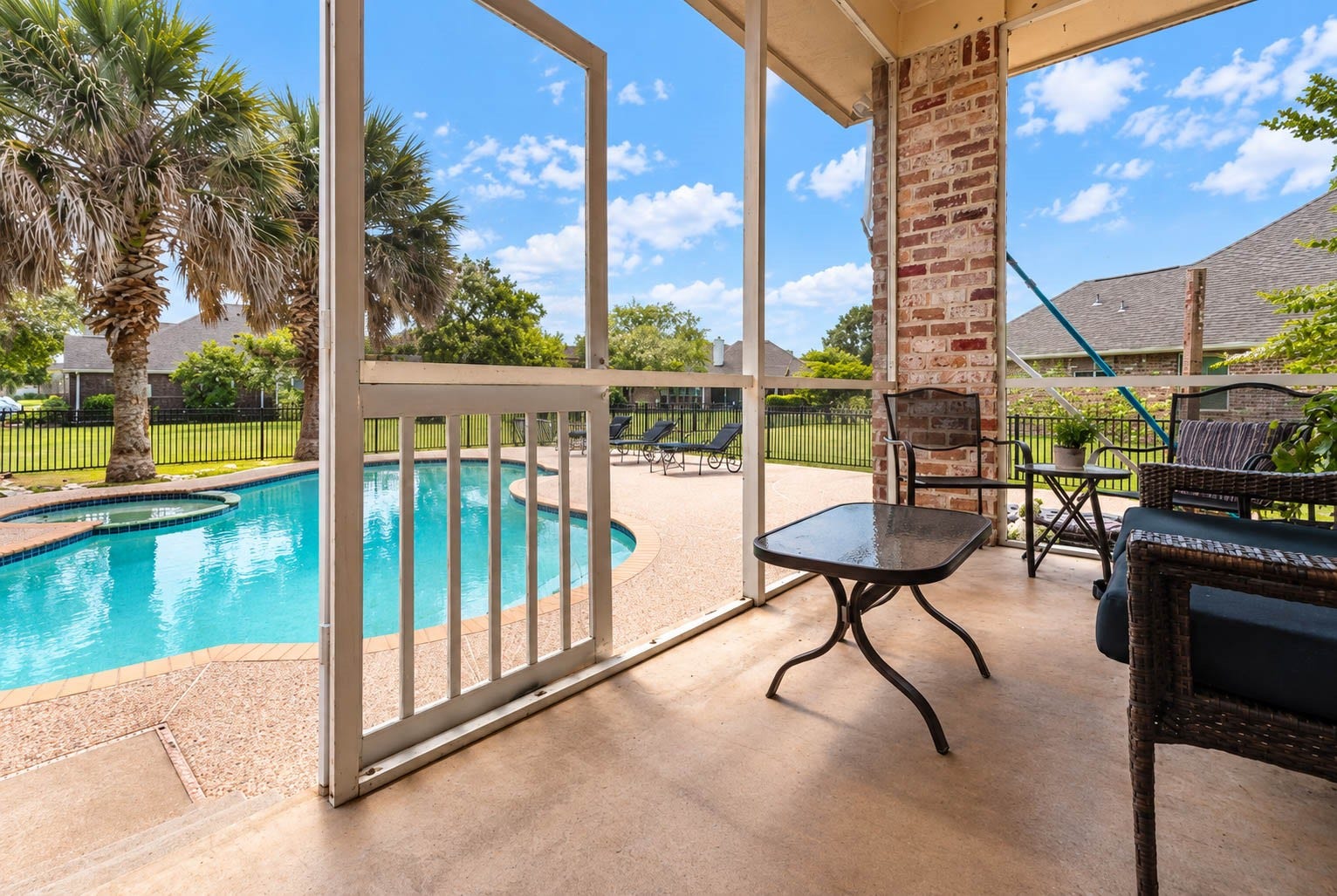 33103 Whickham Circle, Fulshear, TX 77441 The screened porch creates an inviting, sheltered outdoor living space with picturesque views of the sparkling pool & spa. Generous proportions offer plenty of room for comfortable seating, creating a seamless transition from the homes interior to the backyard retreat.