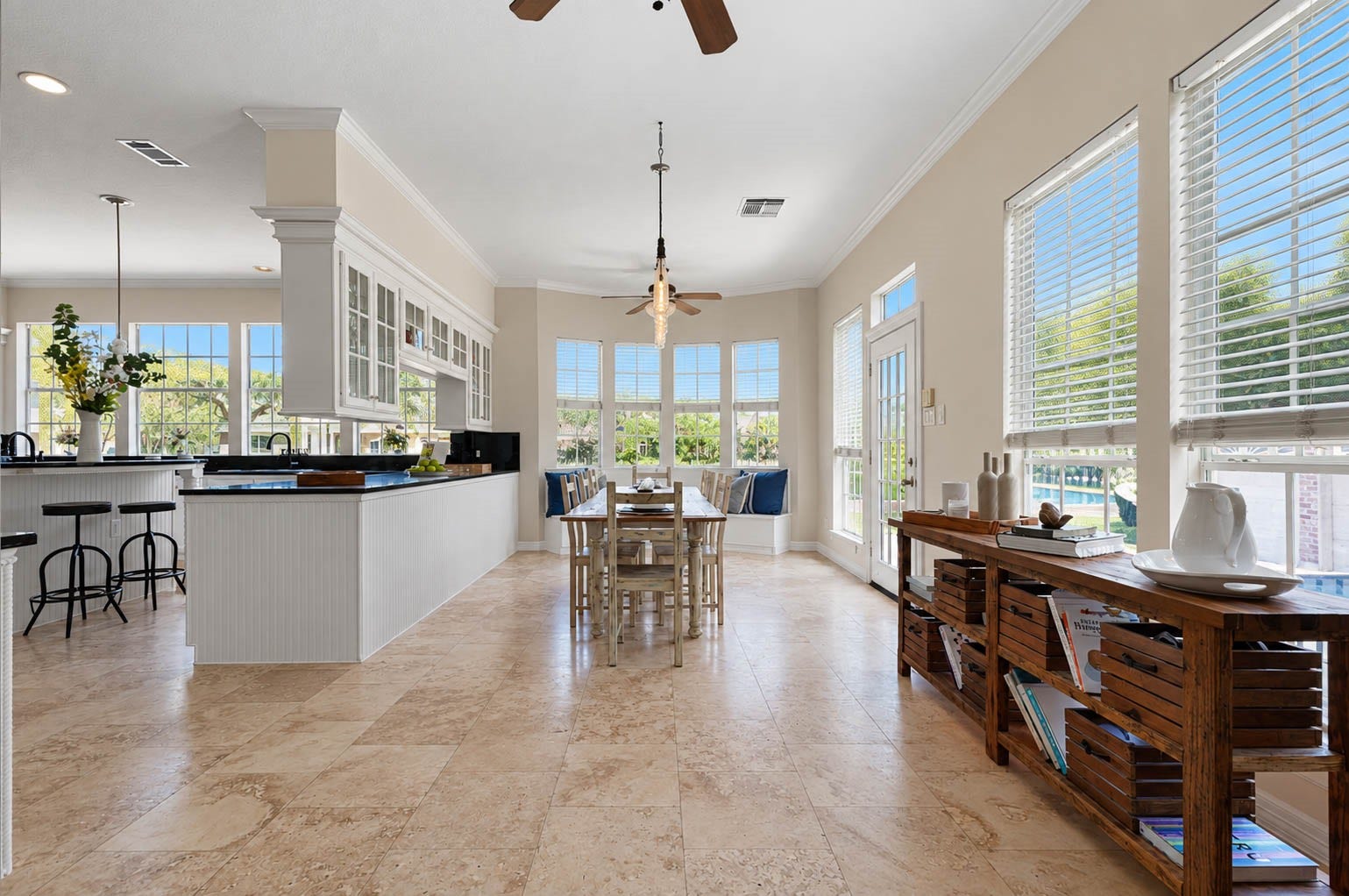 33103 Whickham Circle, Fulshear, TX 77441 Surrounded by expansive windows, the light-filled breakfast area offers beautiful views and an inviting setting for casual dining. Elegant crown molding, a charming built-in bench seat, & a glass-paneled door leading to the back patio add character and effortless connection to the outdoor living spaces.