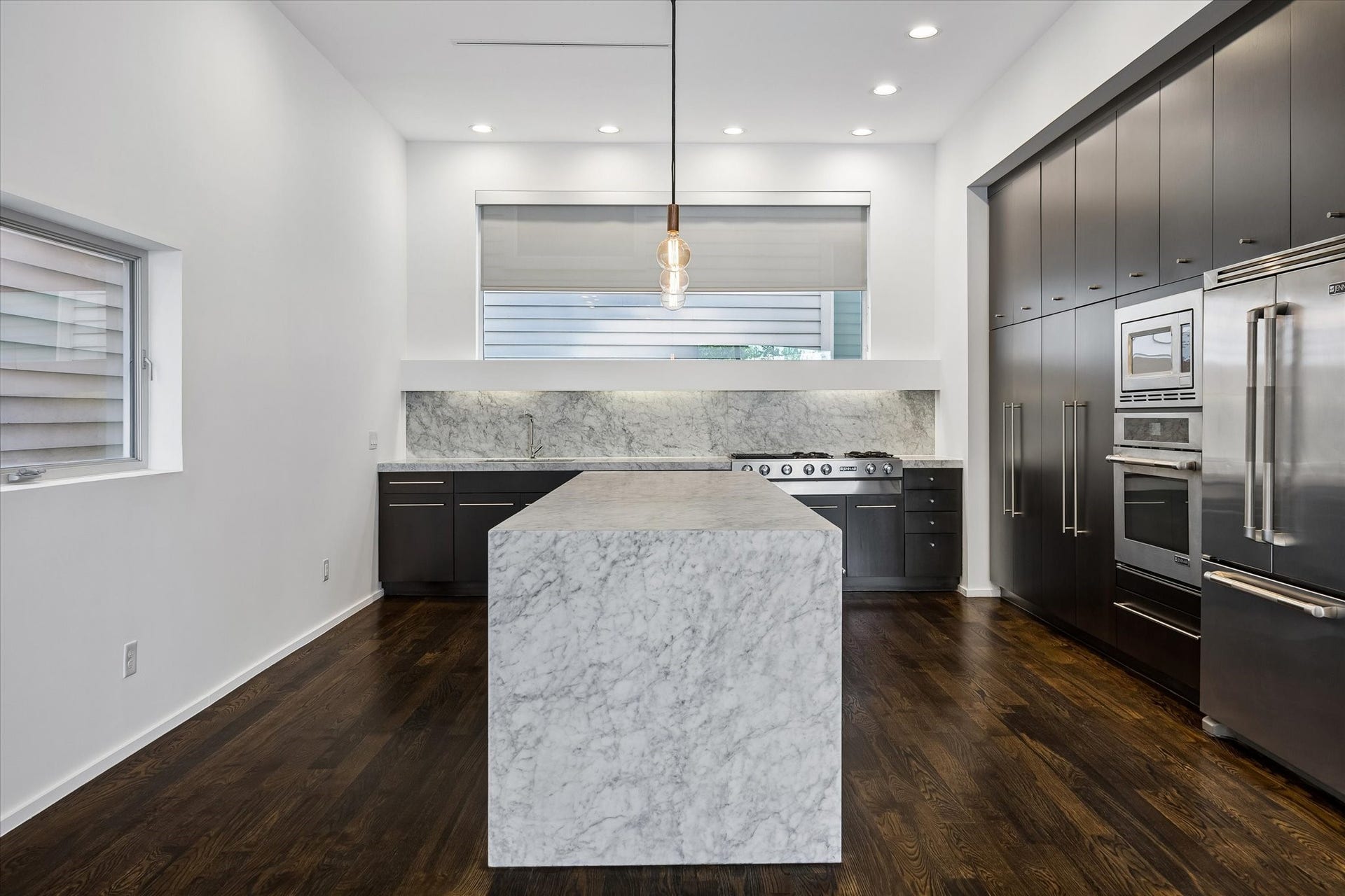 4309 Lillian Street, Houston, TX 77007 The centerpiece of the kitchen is this stunning Carrara marble island with waterfall edge that provides ample room for prep work and seating when entertaining.