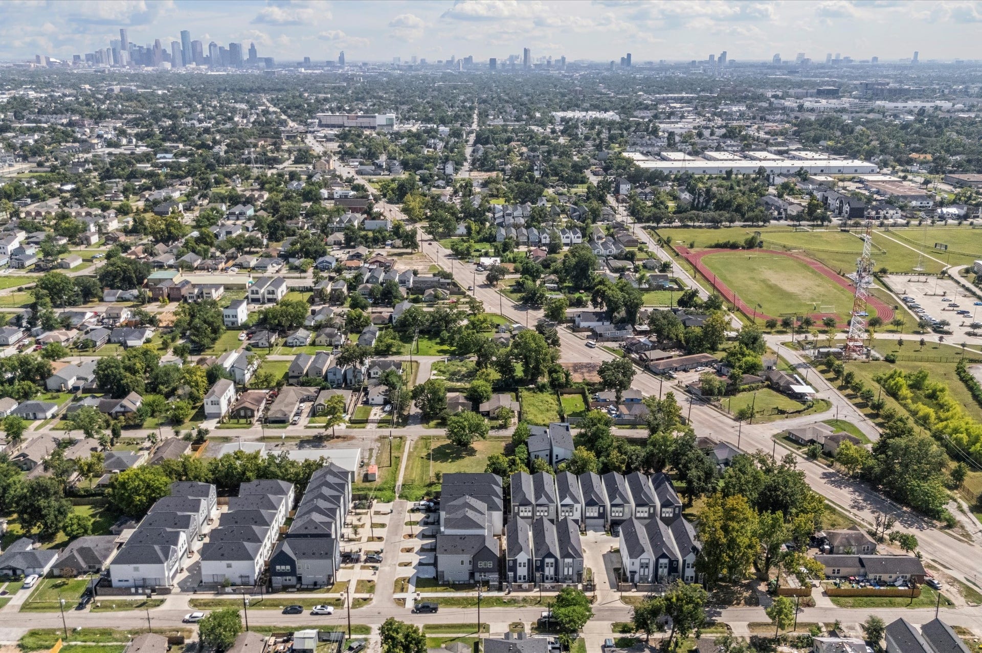 This stunning aerial view highlights the communitys prime location, showcasing surrounding streets, nearby amenities, and the neighborhoods layout, giving a clear perspective of the homes setting and its convenient, connected surroundings.