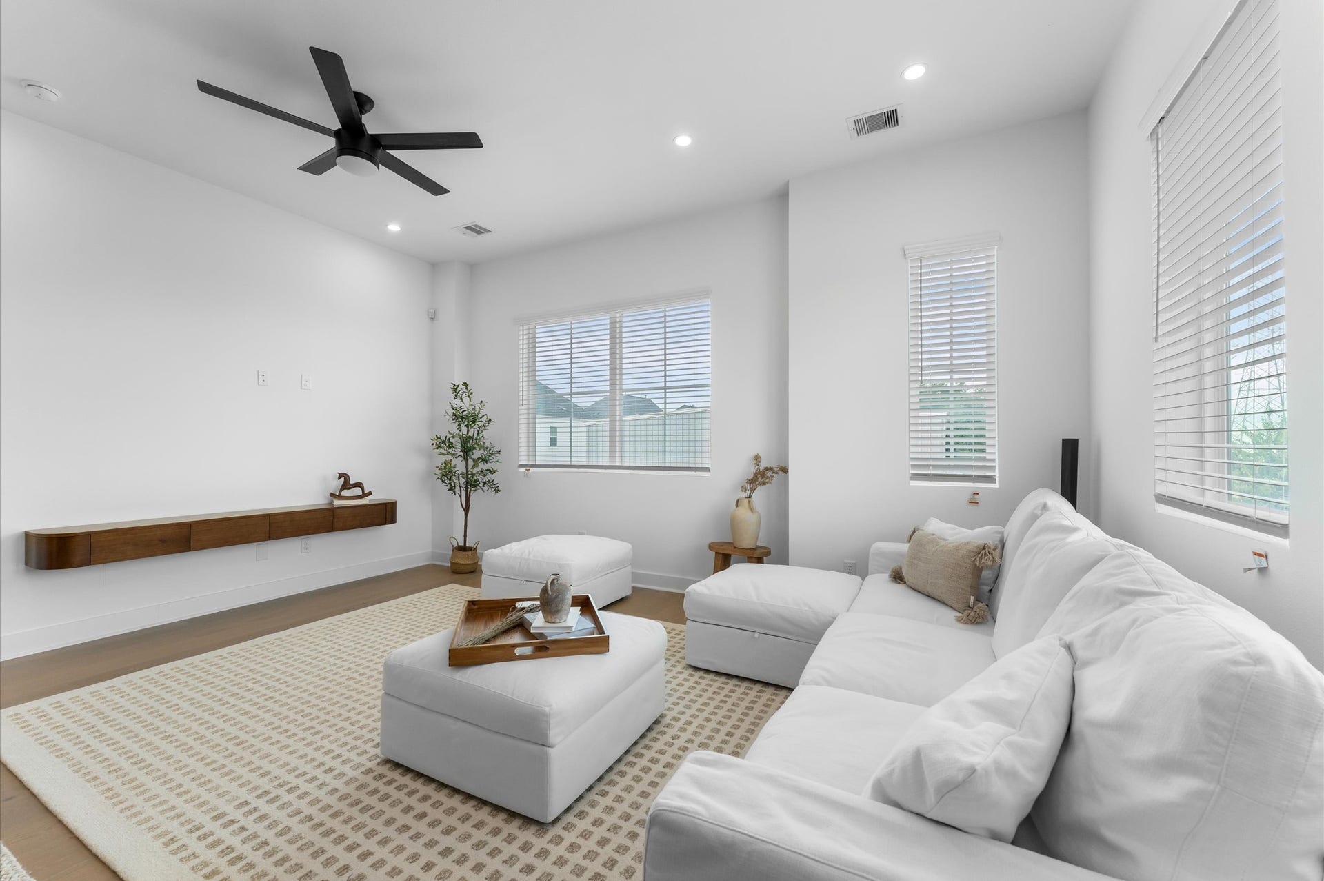 The second floor boasts a spacious open-concept living, dining, and kitchen area filled with natural light from abundant windows, featuring sleek modern finishes and warm engineered hardwood floors that create the perfect blend of style and comfort for everyday living and entertaining.