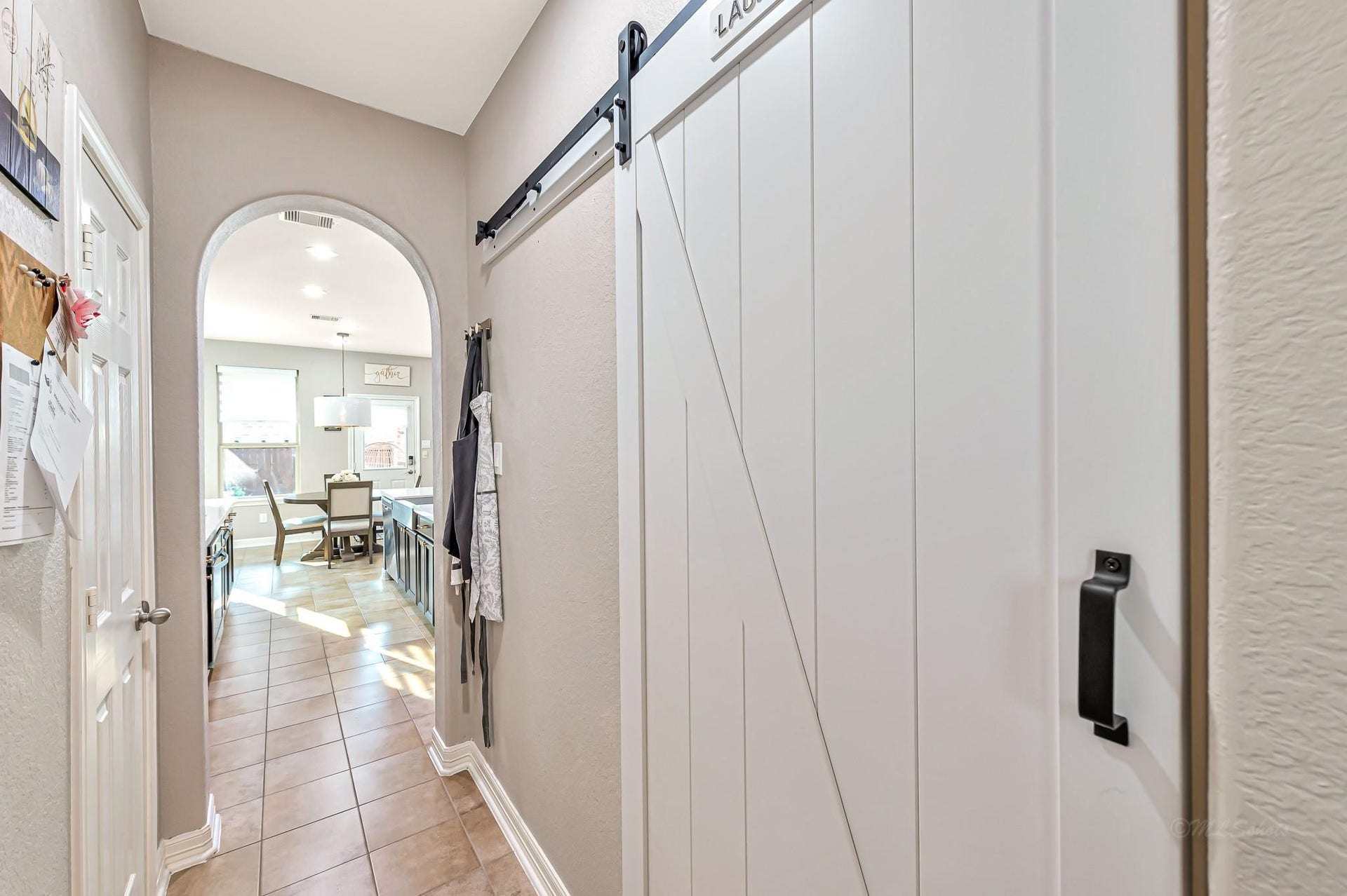 11618 Via Verdone Drive, Richmond, TX 77406 Barn door slides to expose utility room with top of the line washer and dryer