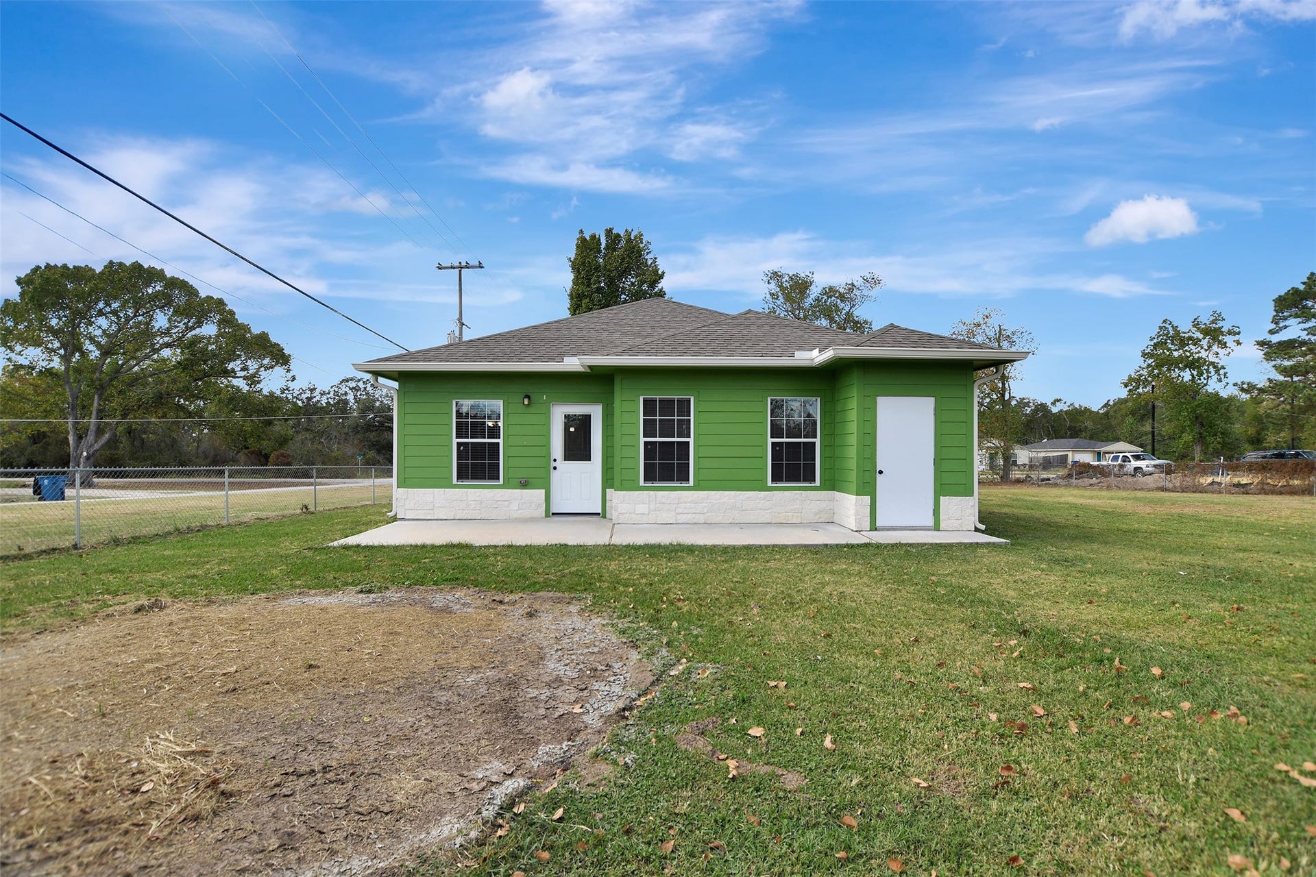 2546 16th Street, Hempstead, TX 77445 Home has a modest back porch with extra storage to the right, and a large yard.