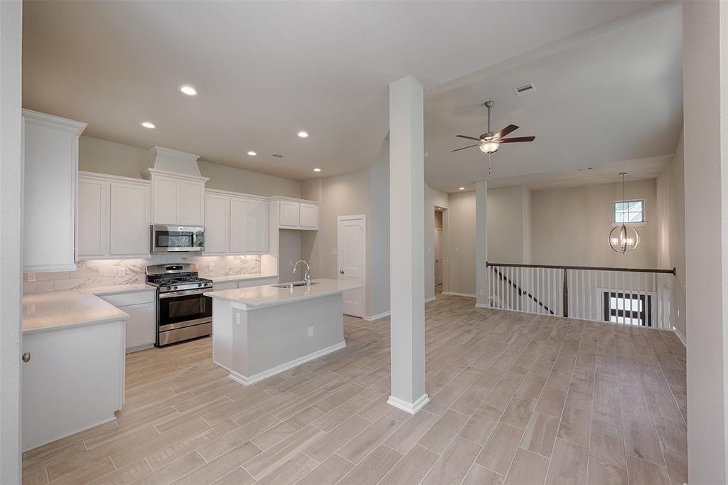 115 Handley Drive, Montgomery, TX 77316 Loads of cabinets and large pantry. Gas range, microwave, and dishwasher included.