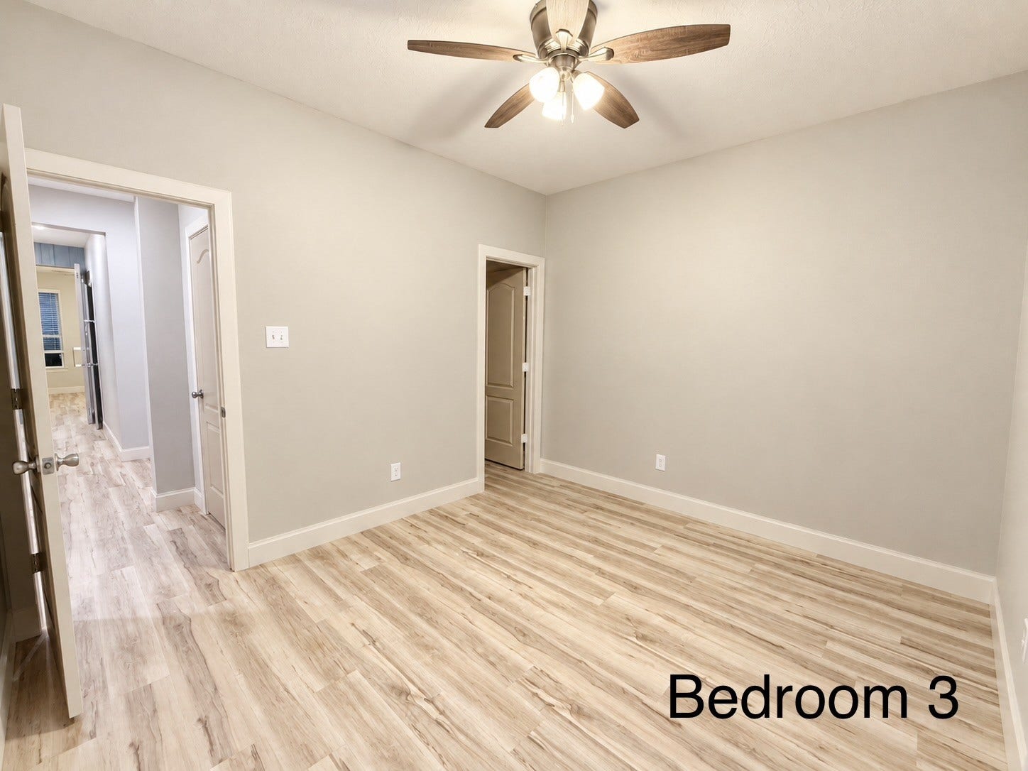 The final bedroom offers a walk-in closet, adding to the comfort of the space.