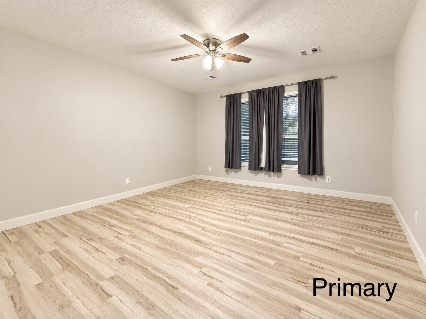 The primary bedroom is conveniently located off the living space and separate from the other bedrooms, offering a private retreat.