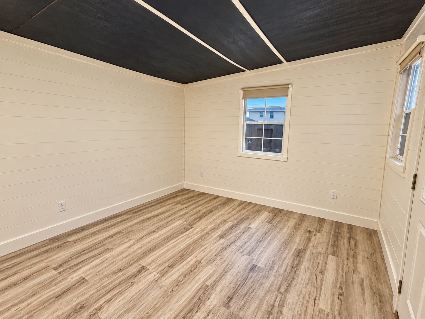 This 10' x 12' shed is fully finished and features a window unit, making it an ideal space for a hobby room, home office, or private media room.