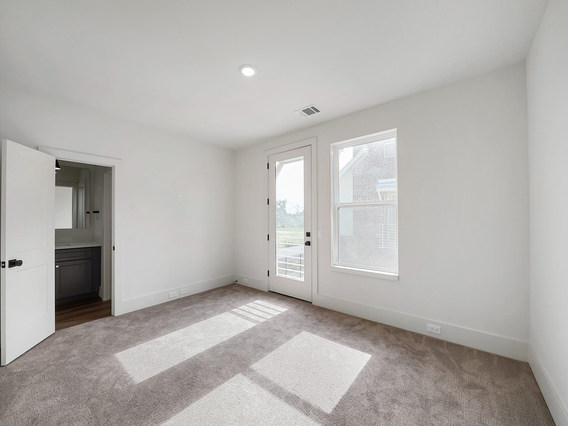 881 Rachel Street, #A, Houston, TX 77091 Bright, spacious room with fresh carpet, neutral walls, and ample natural light. Features include a window, glass door, and access to a small bathroom with dark cabinetry.
Photo Disclaimer: Photos are representative of the community and may depict a similar floor plan, model home, or previously completed residence.