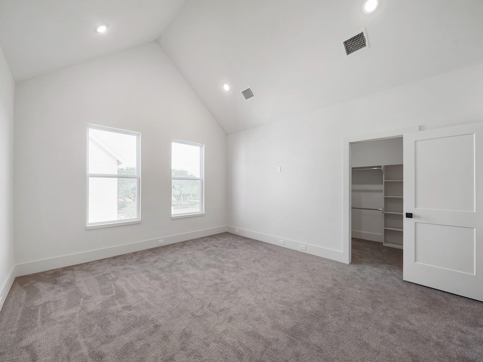 881 Rachel Street, #A, Houston, TX 77091 Bright and spacious bedroom with high ceilings, neutral tones, two large windows for natural light, and a walk-in closet with sliding door.
Photo Disclaimer: Photos are representative of the community and may depict a similar floor plan, model home, or previously completed residence.