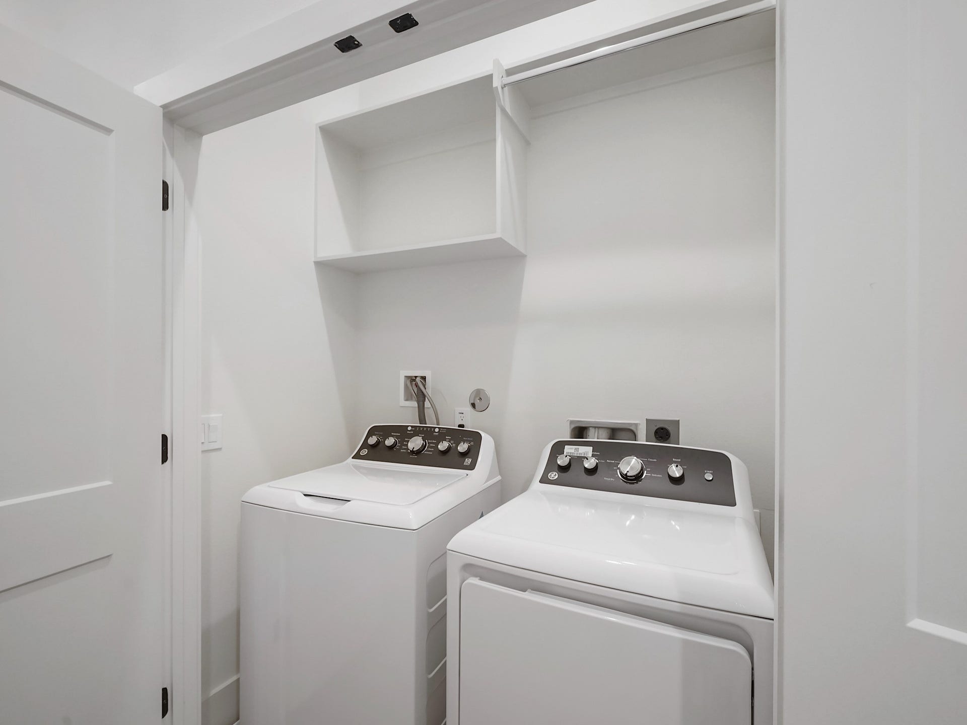 881 Rachel Street, #A, Houston, TX 77091 This photo shows a compact laundry area with a white washer and dryer set, open shelving above, and a clean, minimalist design.
Photo Disclaimer: Photos are representative of the community and may depict a similar floor plan, model home, or previously completed residence.
