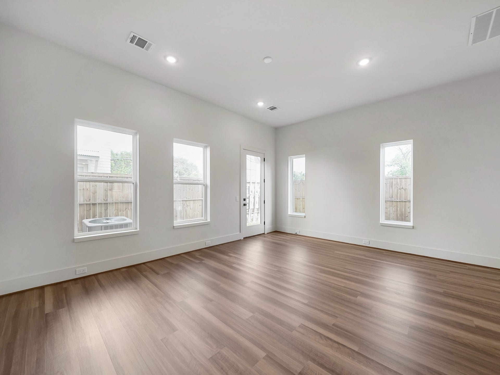 881 Rachel Street, #A, Houston, TX 77091 This spacious, bright room features modern recessed lighting, large windows, and a glass door leading to an outdoor area. The light wood flooring adds warmth, while white walls provide a clean, fresh look, perfect for a versatile living space.
Photo Disclaimer: Photos are representative of the community and may depict a similar floor plan, model home, or previously completed residence.