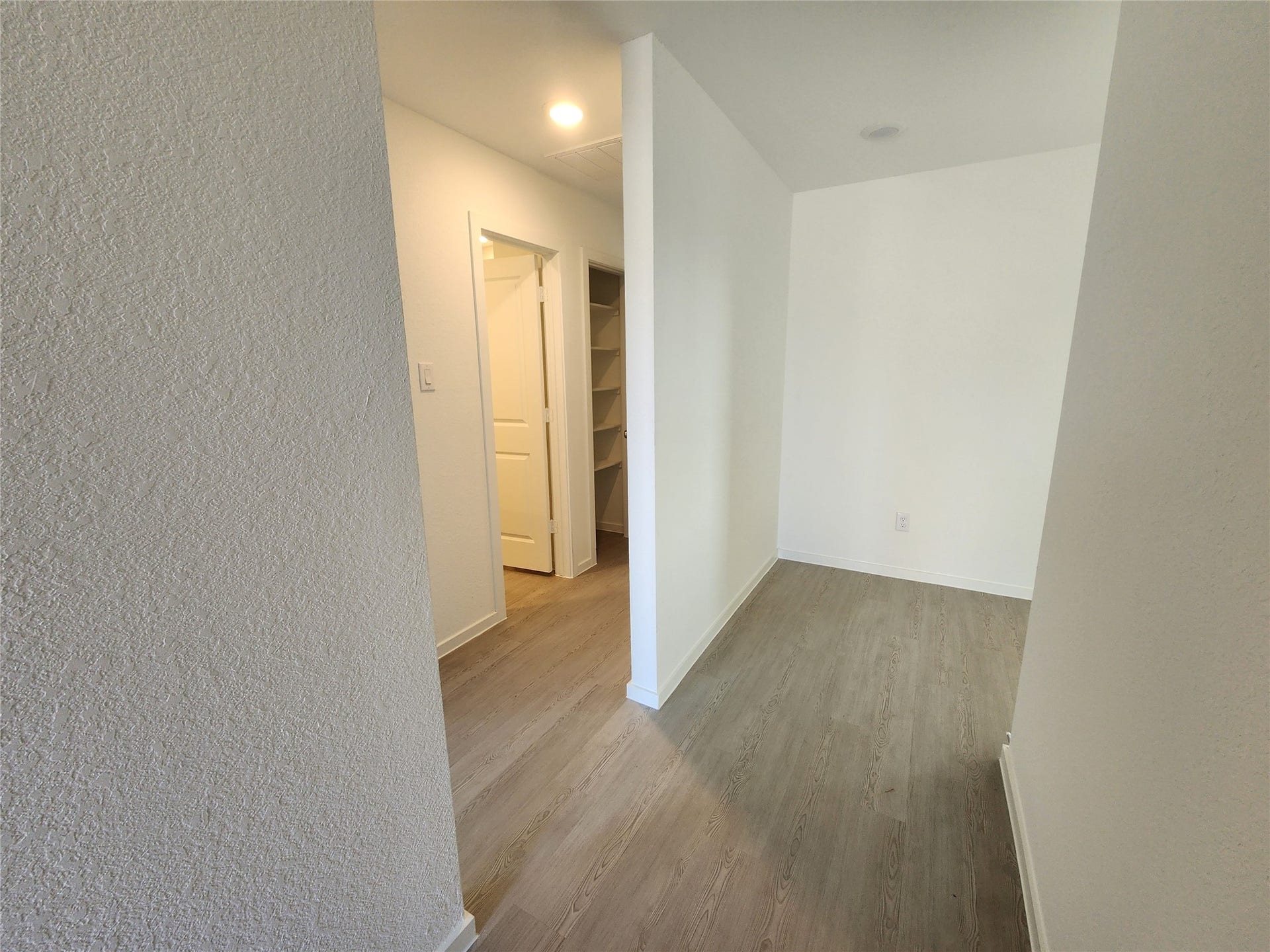 17307 Adina Creek Court, Crosby, TX 77532 Entry way leading from front door leads to a hallway with entrances to two secondary bedrooms and secondary bathroom. Straight ahead leads to open concept living area/kitchen.