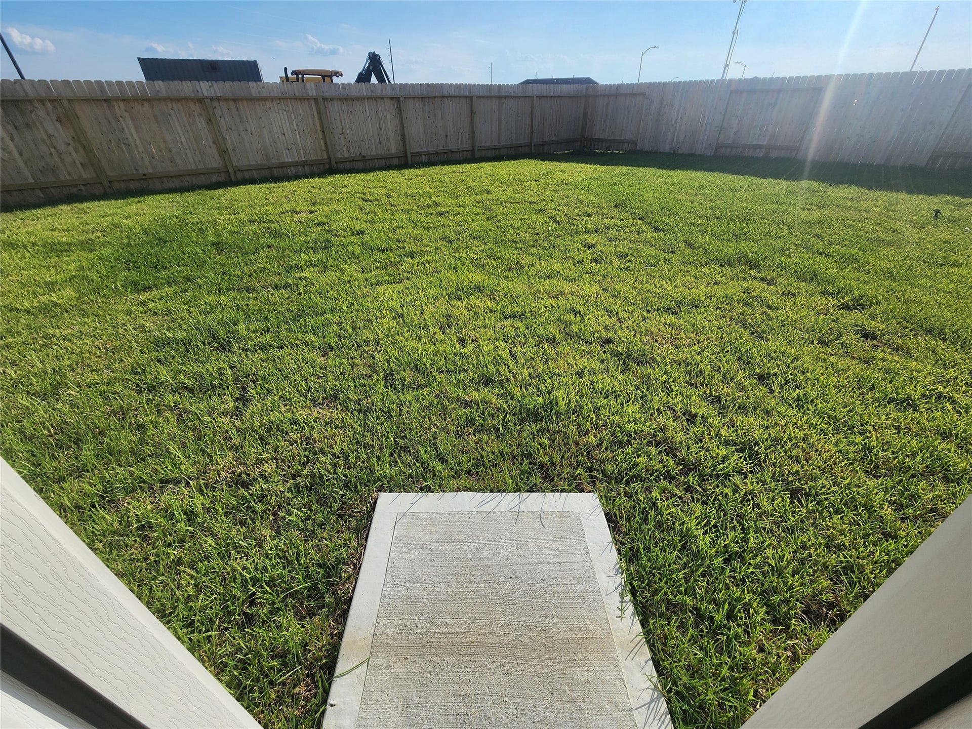 17307 Adina Creek Court, Crosby, TX 77532 Spacious backyard with a well-maintained grassy lawn, enclosed by a wooden fence for privacy.