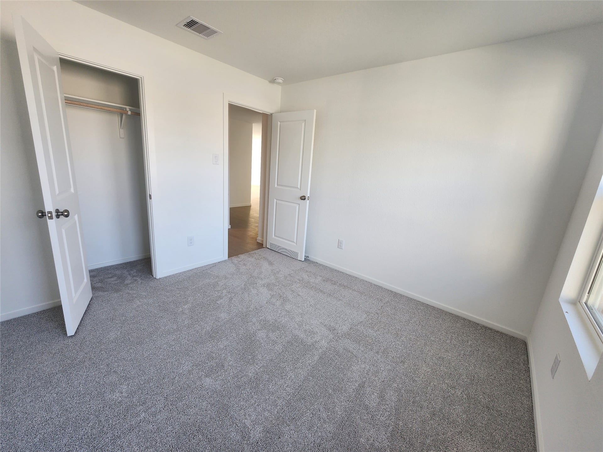 17307 Adina Creek Court, Crosby, TX 77532 Bright secondary bedroom with recessed lighting and carpet.