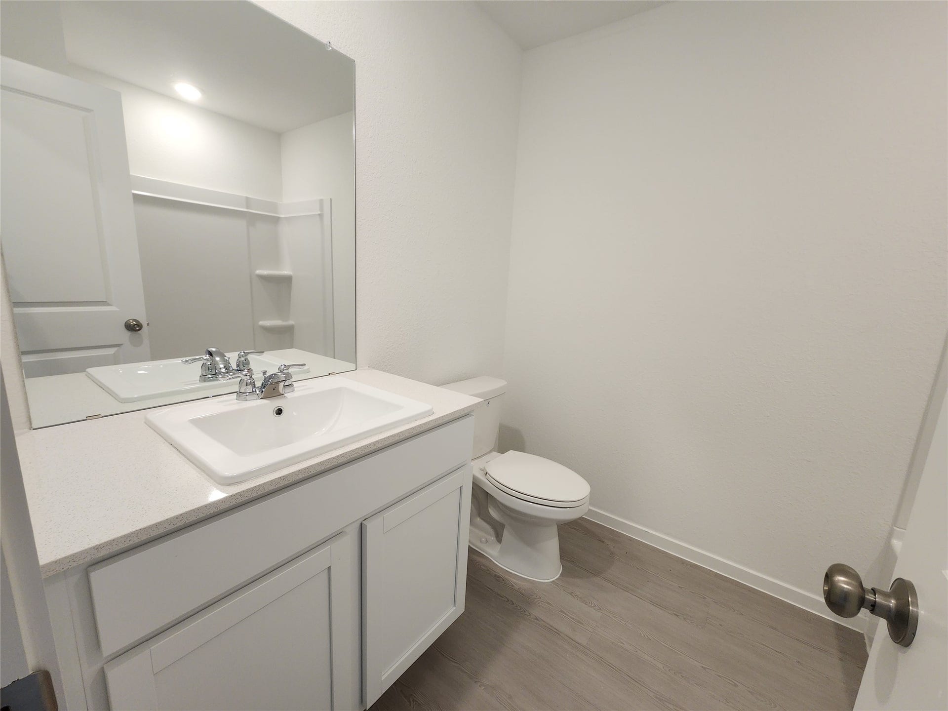 17307 Adina Creek Court, Crosby, TX 77532 Secondary bathroom features a modern design with a white vanity, spacious countertop, large mirror, and a tub/shower combo.