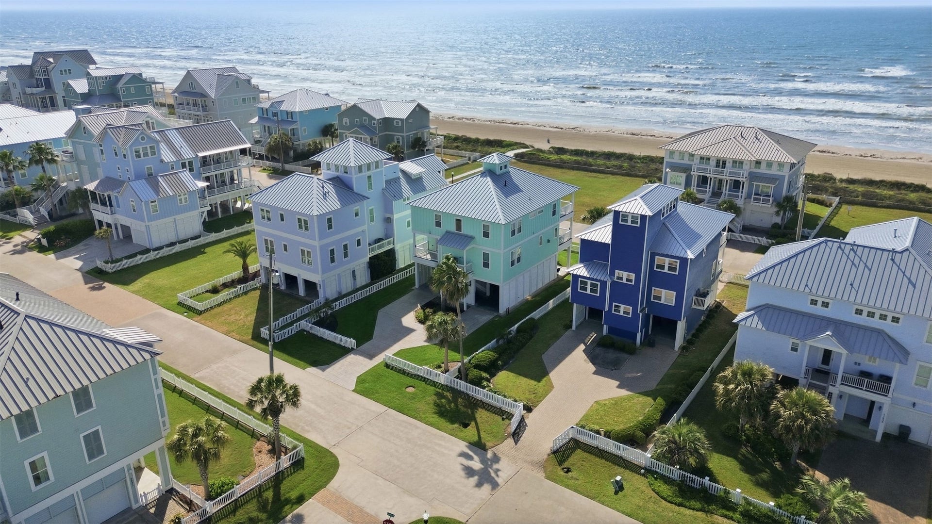 11622 Beachside, Galveston, TX 77554 Surrounded by well-maintained lawns and palm trees. The properties are set in a picturesque neighborhood, a serene beachside location.