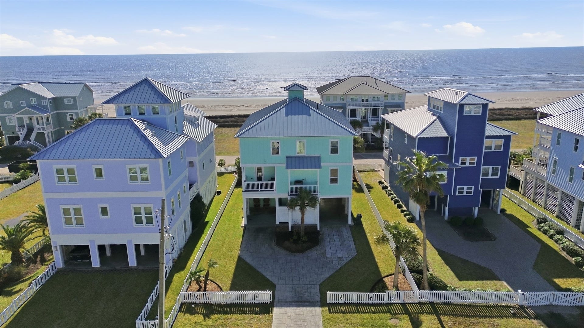 11622 Beachside, Galveston, TX 77554 Surrounded by manicured lawns and swaying palm trees, this home offers a serene, picturesque setting with beautiful ocean views. The spacious driveway comfortably accommodates up to six vehicles, providing plenty of room for guests.