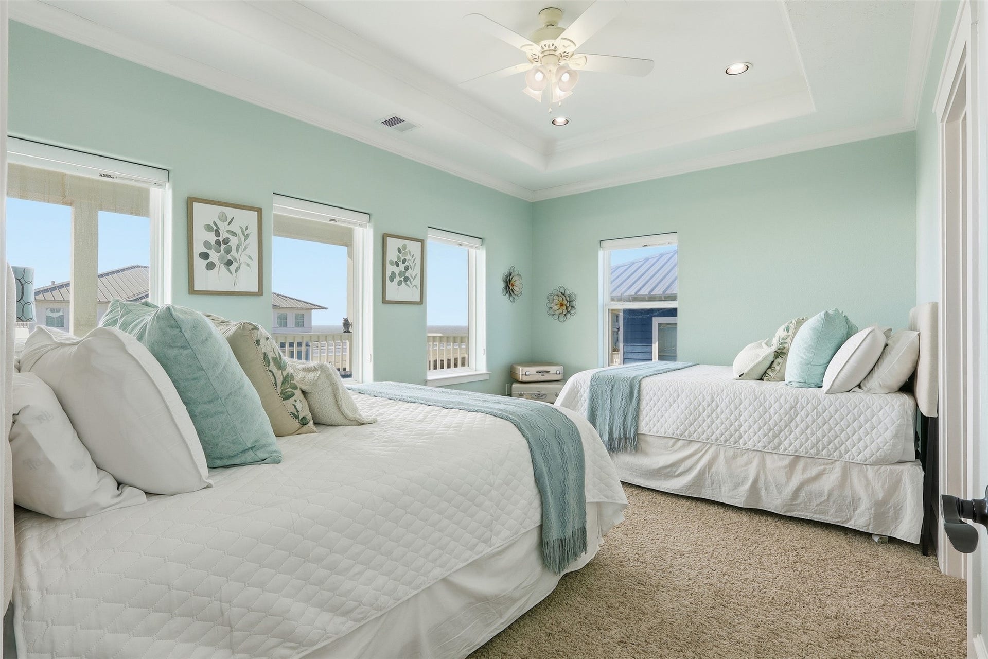 11622 Beachside, Galveston, TX 77554 This bedroom showcases serene coastal dcor with two queen beds and abundant natural light streaming in from multiple windows. Spacious and inviting, it offers plenty of room to relax and unwind.