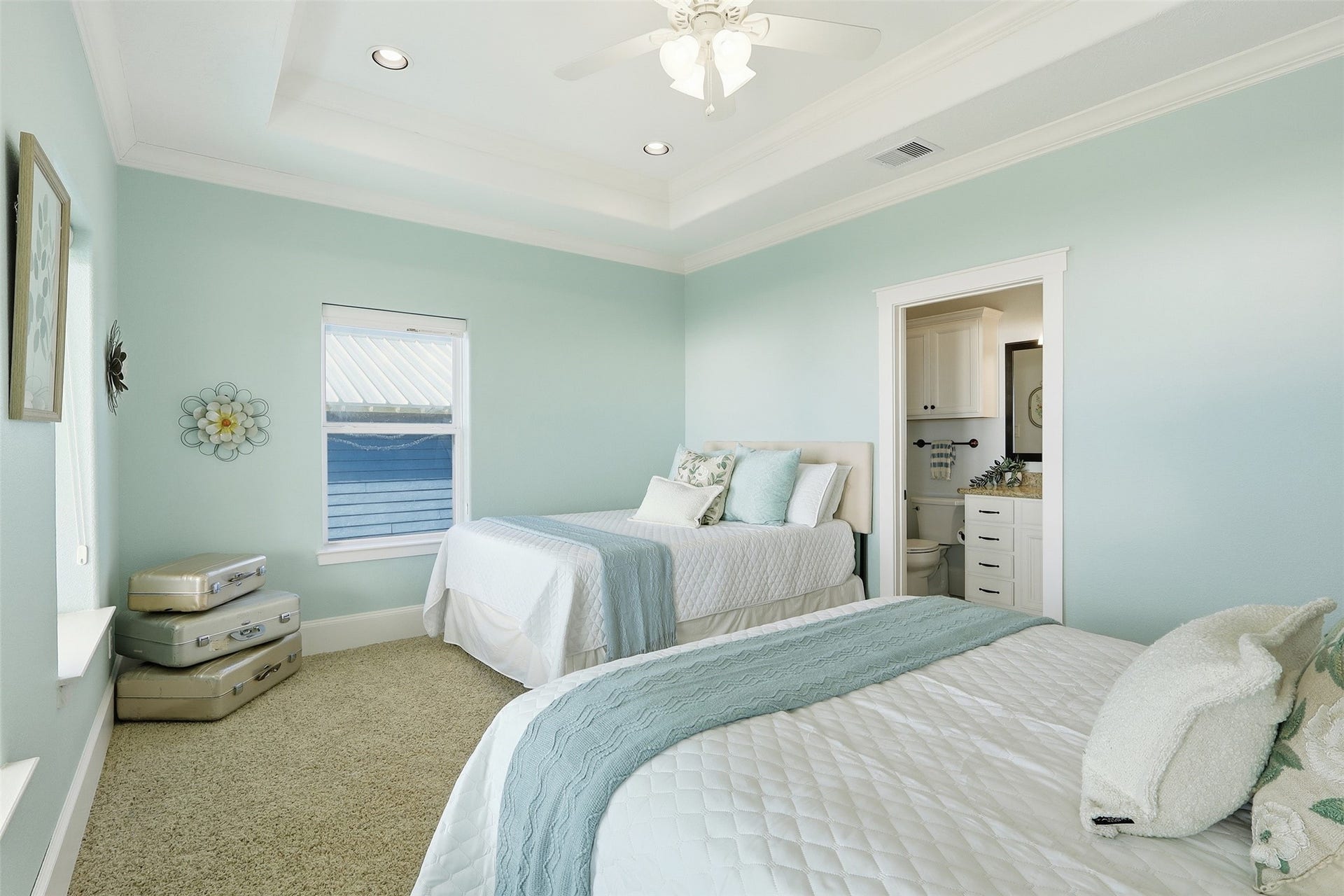 11622 Beachside, Galveston, TX 77554 This bedroom features a tray ceiling with recessed lighting and an en-suite bathroom. Elegant and serene, ideal for relaxation.