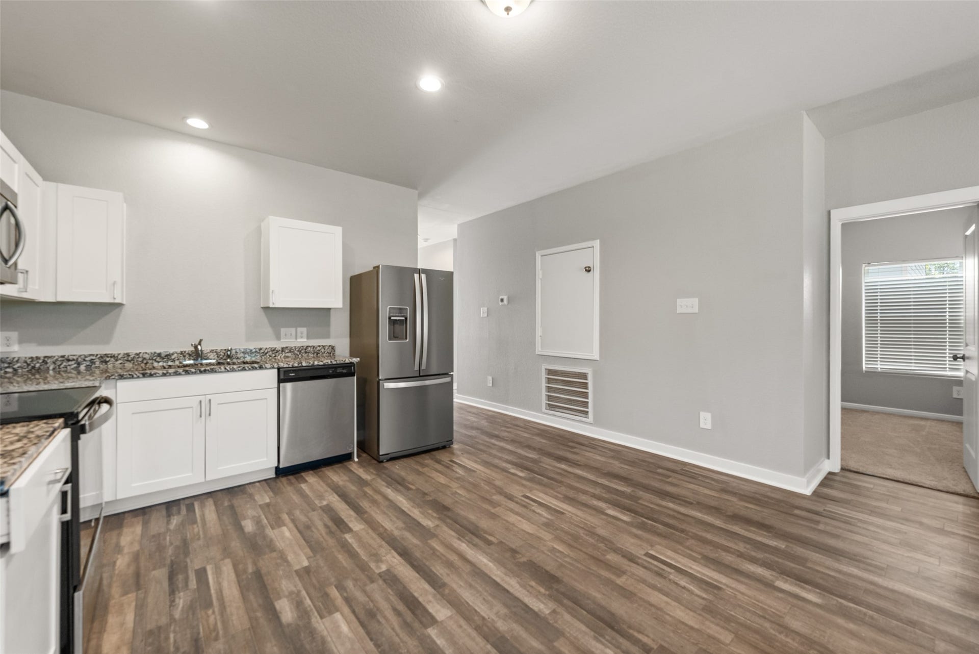 2537 18th Street, Hempstead, TX 77445 Kitchen and dining view featuring stainless steel appliances, abundant cabinetry, recessed lighting, and an open connection to the living area.