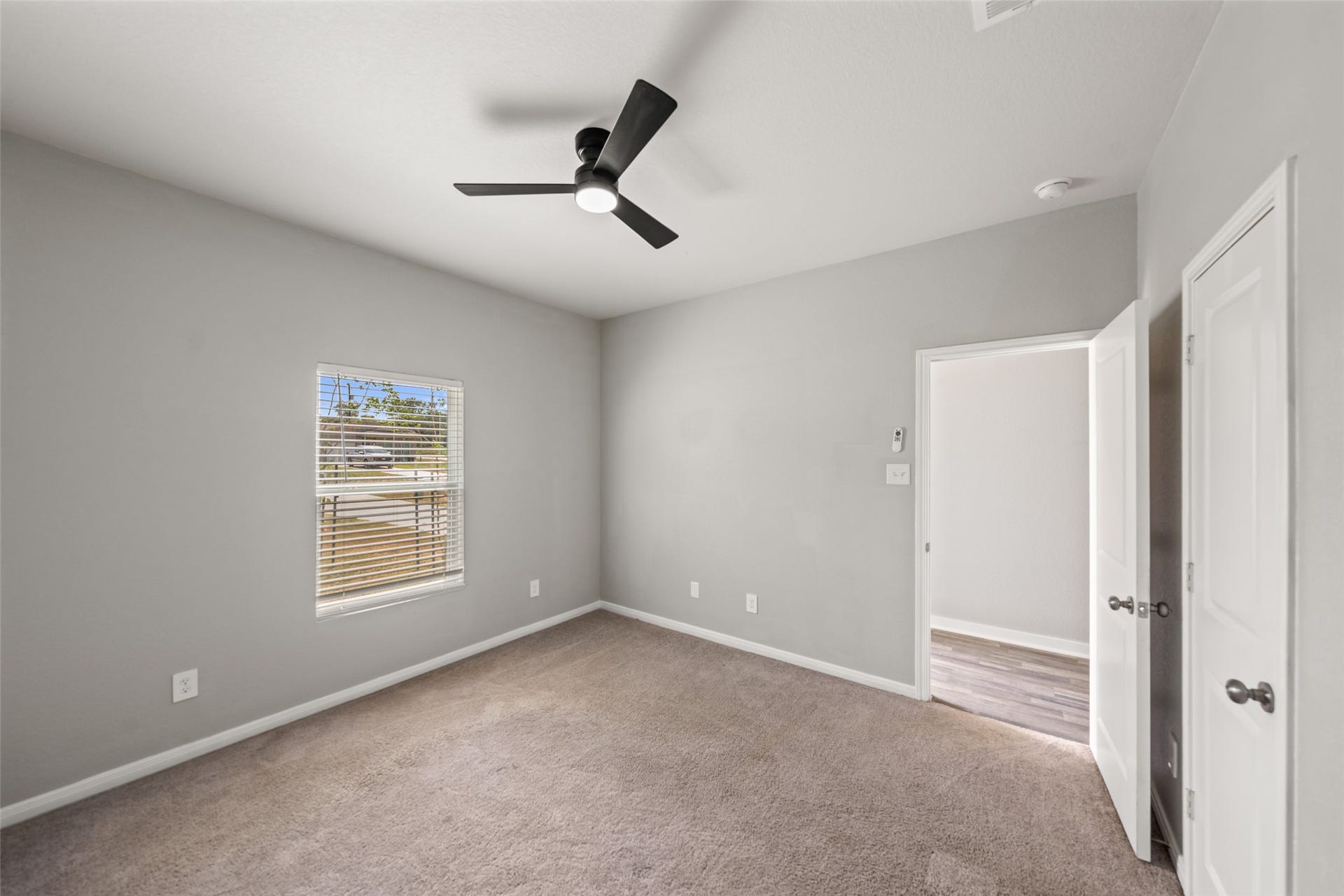 2537 18th Street, Hempstead, TX 77445 Additional bedroom view showcasing the ceiling fan, carpet flooring, and comfortable room dimensions.