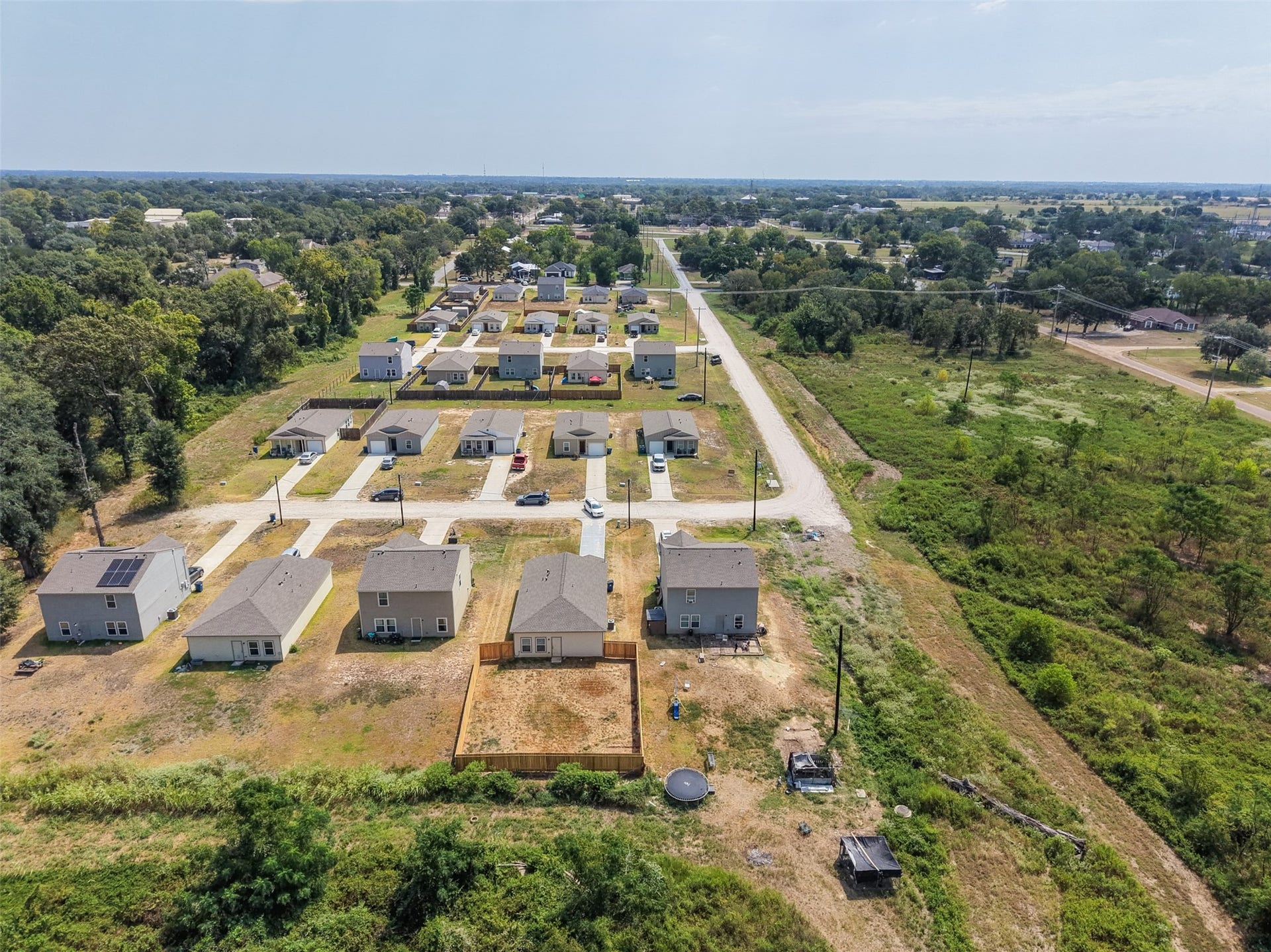 2537 18th Street, Hempstead, TX 77445 Wide aerial view showcasing the surrounding residential development, neighborhood layout, and nearby open acreage