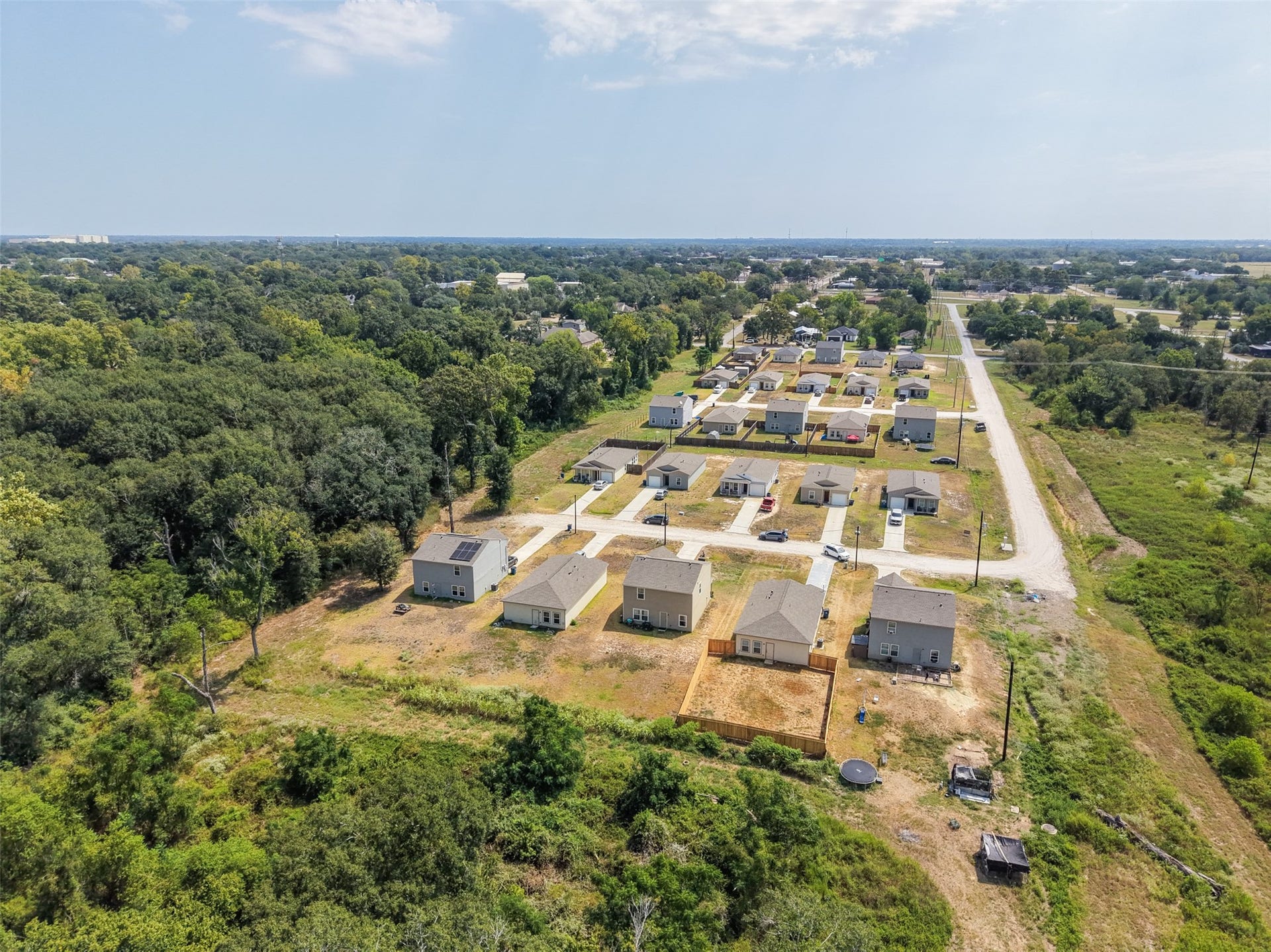 2537 18th Street, Hempstead, TX 77445 Elevated aerial perspective highlighting the communitys newer homes, paved streets, and surrounding open space.