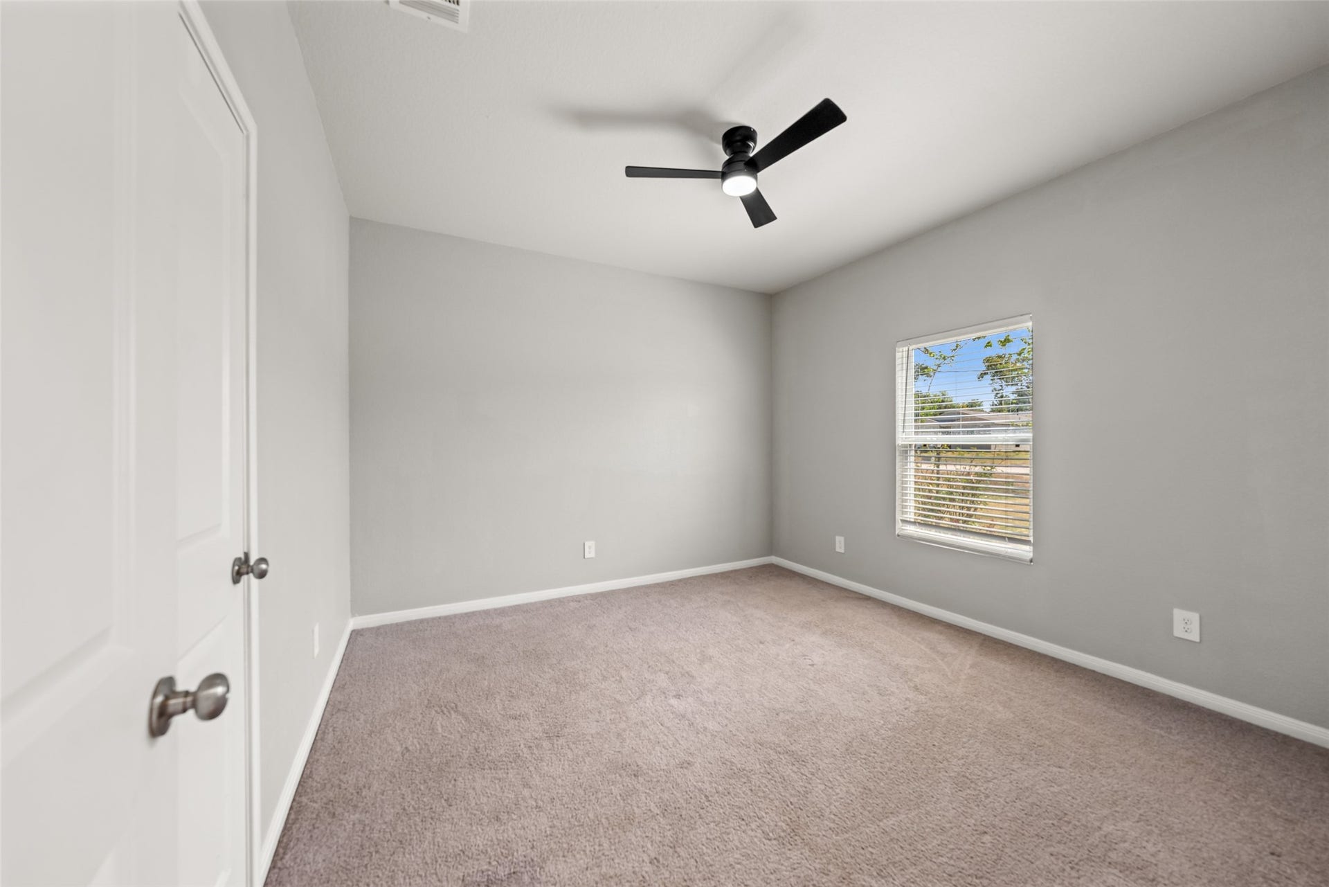 2537 18th Street, Hempstead, TX 77445 Spacious bedroom featuring carpet flooring, ceiling fan, and neutral finishes ready for personalization.