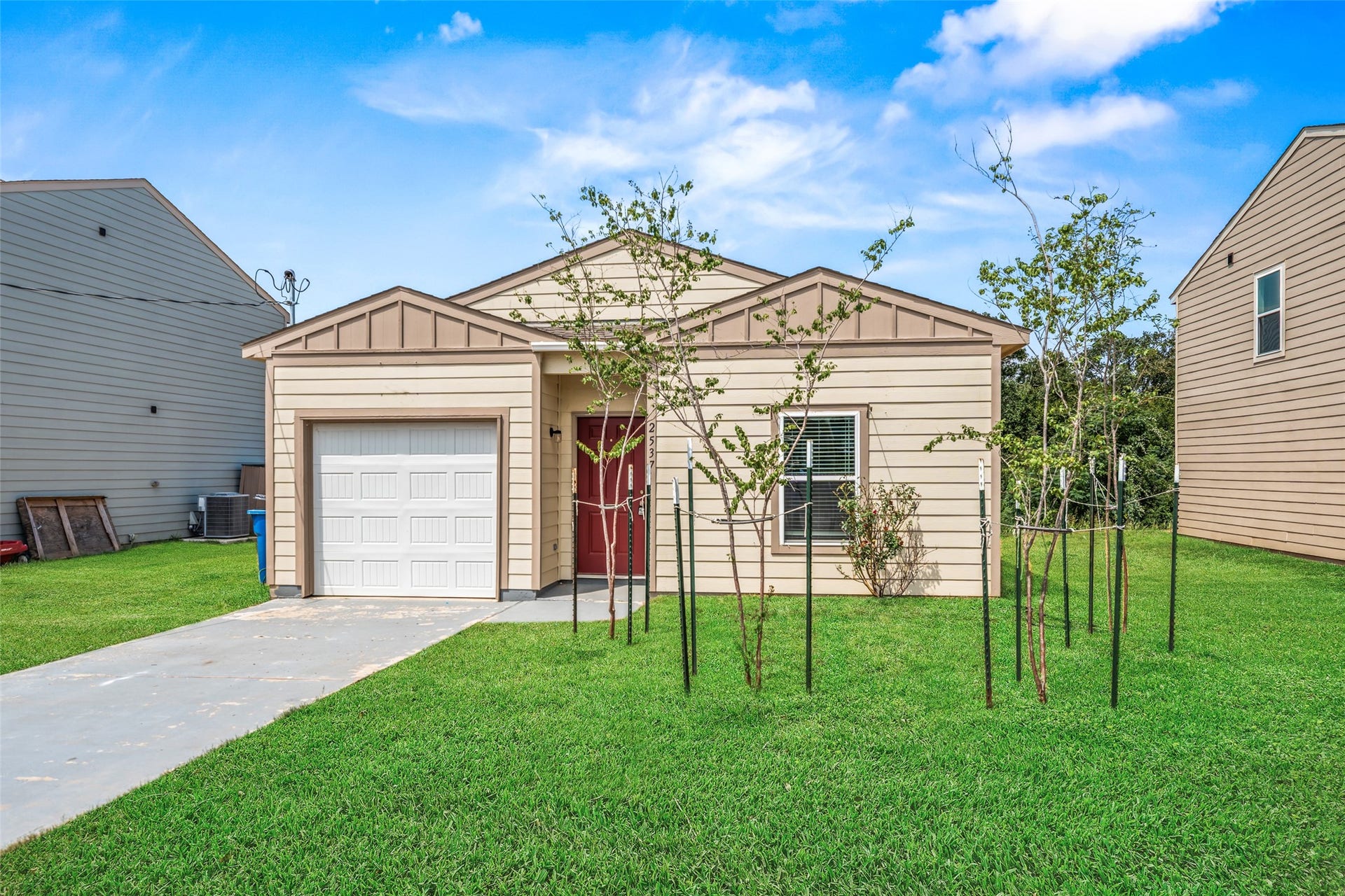 2537 18th Street, Hempstead, TX 77445 Inviting front view highlighting the homes attractive exterior, attached garage, landscaped entry, and spacious front yard.
