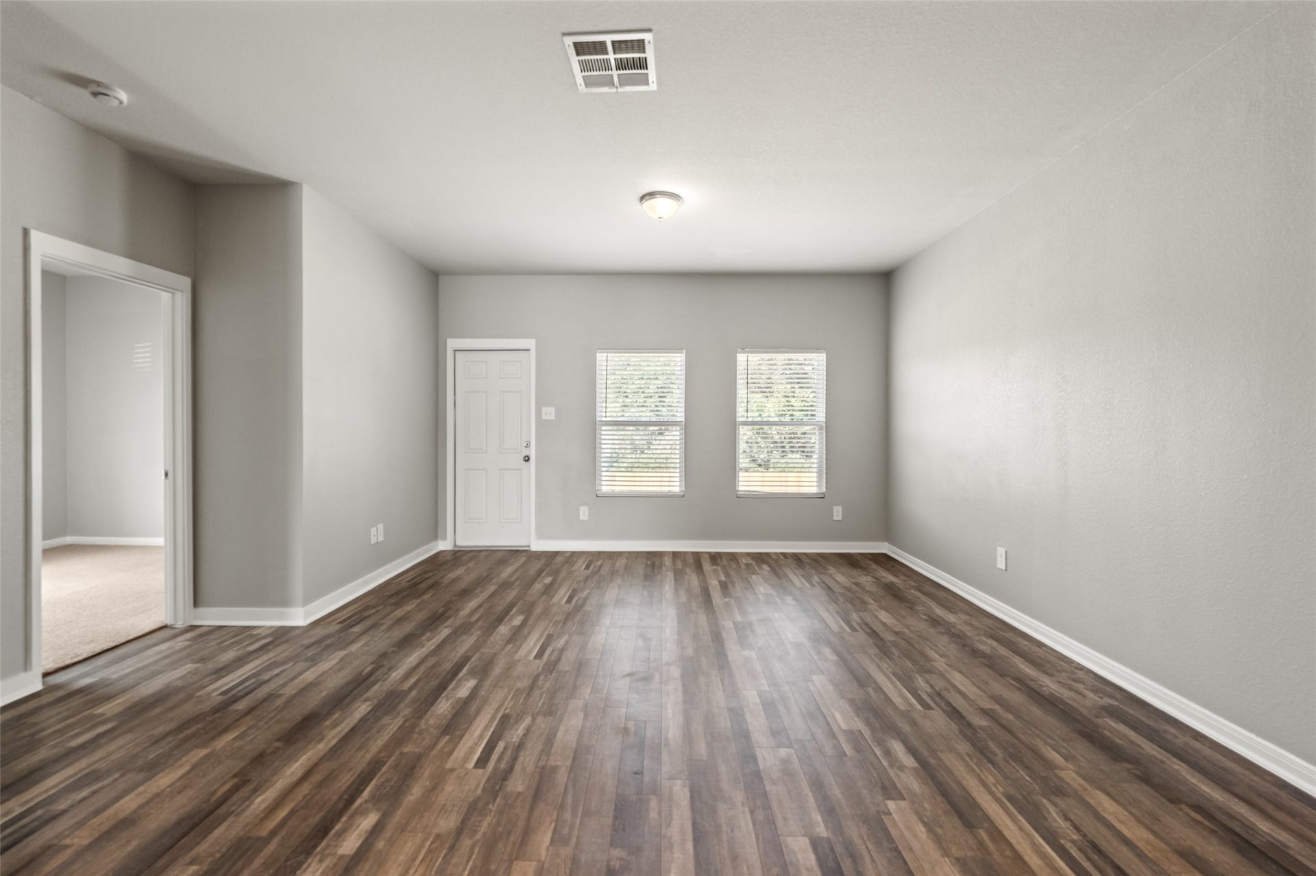 2537 18th Street, Hempstead, TX 77445 Spacious dining area with wood-look flooring, neutral finishes, and windows providing abundant natural light.