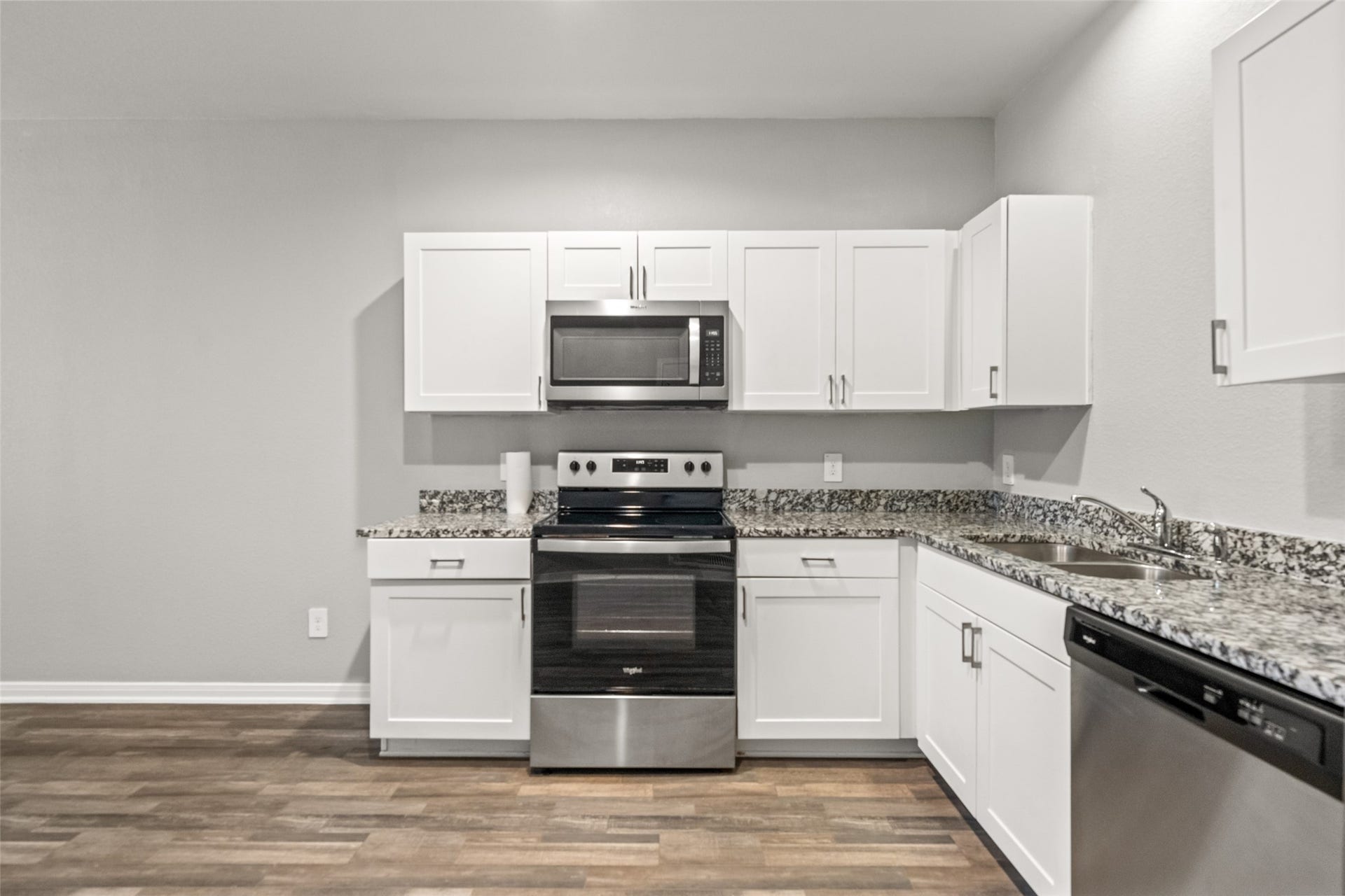 2537 18th Street, Hempstead, TX 77445 Kitchen featuring granite countertops, white cabinetry, stainless steel appliances, subway tile backsplash, and generous workspace.