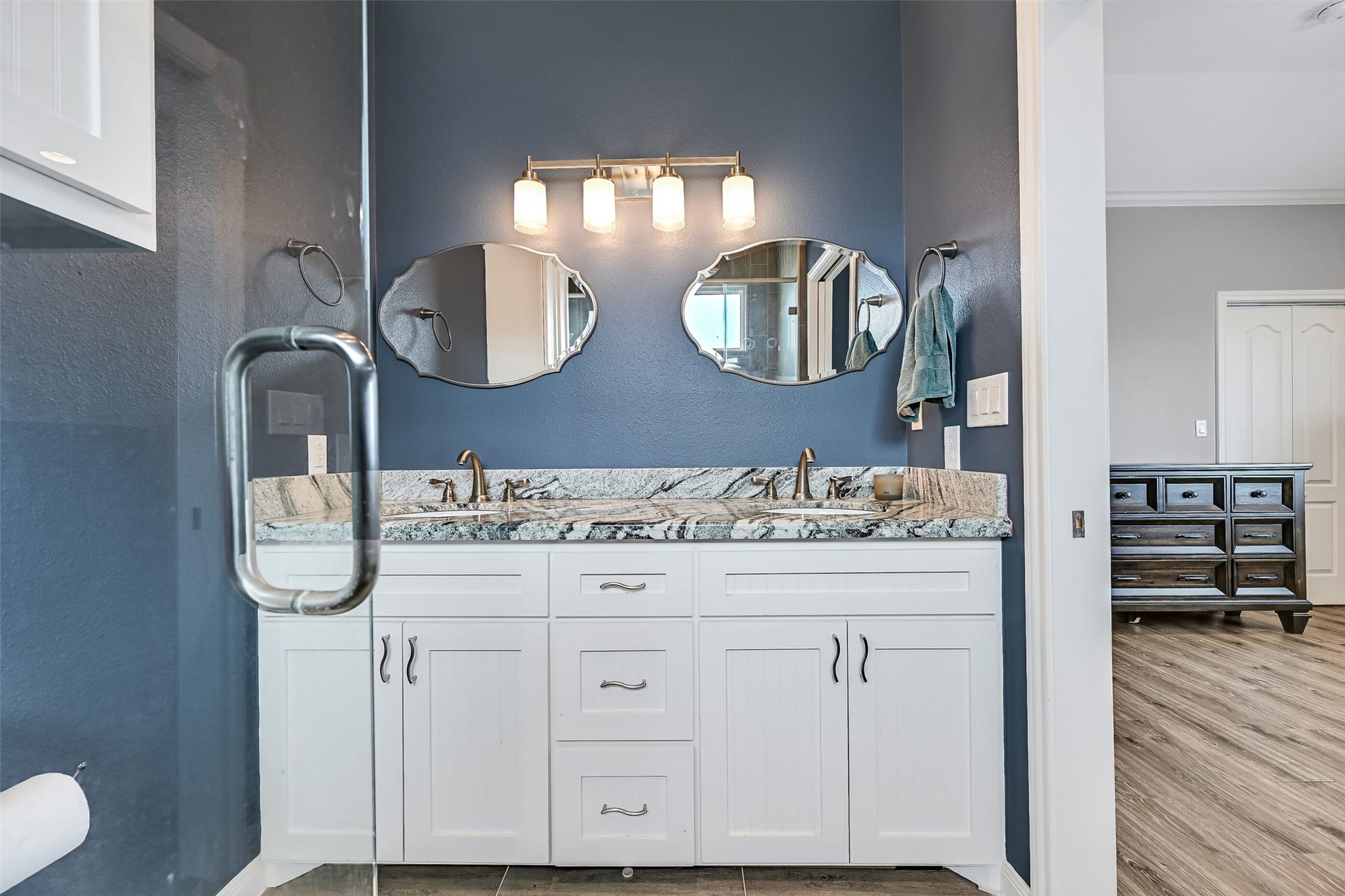 7119 Beau Rue Street, Hitchcock, TX 77563 The vanity features beadboard accent shaker cabinetry, while undermount sinks and nickel fixtures completes the package.
