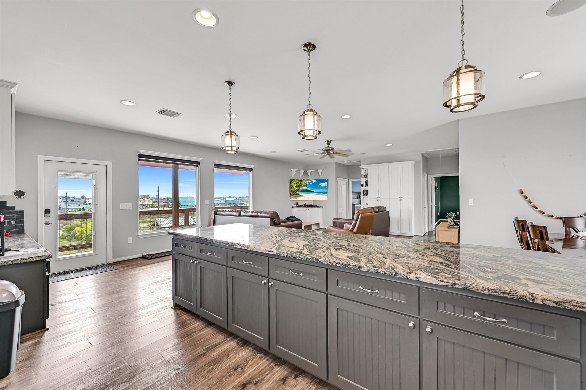 7119 Beau Rue Street, Hitchcock, TX 77563 Lots of space to entertain! You will even enjoy a water view from your kitchen. Notice the designer pendant lighting above.