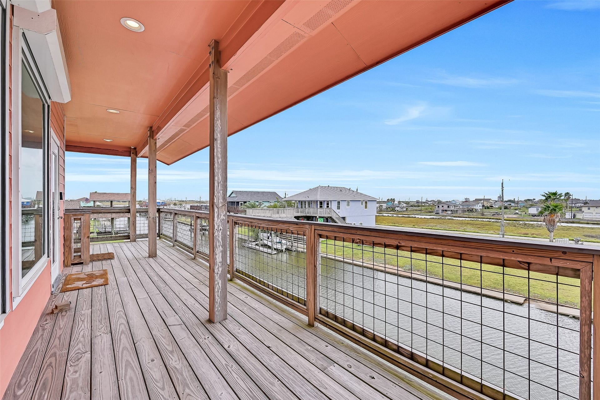 7119 Beau Rue Street, Hitchcock, TX 77563 Once on the main level, we come to the expansive wrap-around covered decking. No matter where you are on this deck, you will always have a water view!