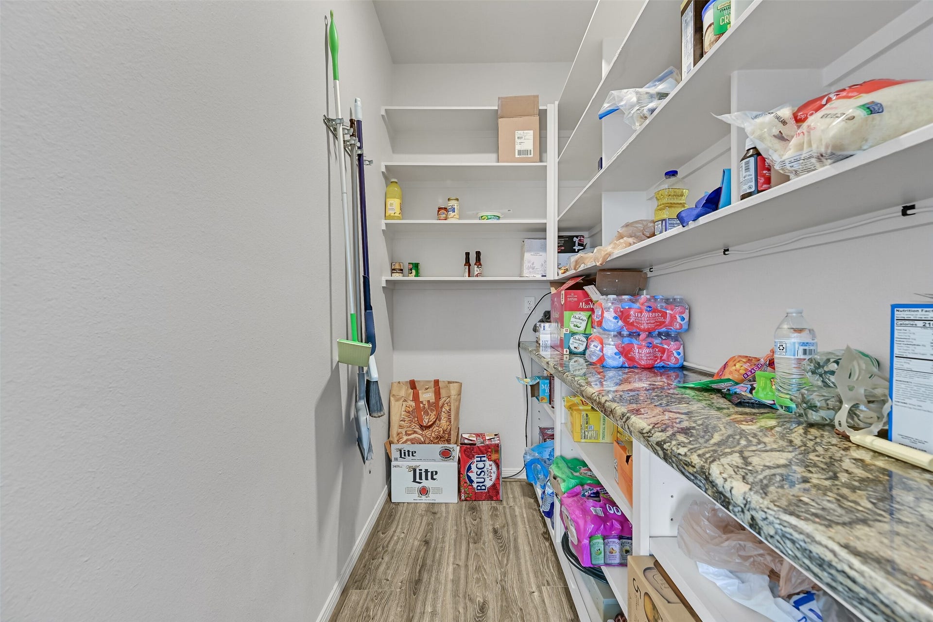 7119 Beau Rue Street, Hitchcock, TX 77563 Here is your oversized walk-in pantry! Something you don't even find in homes these days - well this is the one that will cater to all of your Costco runs! Notice the luxurious granite spills into the pantry.