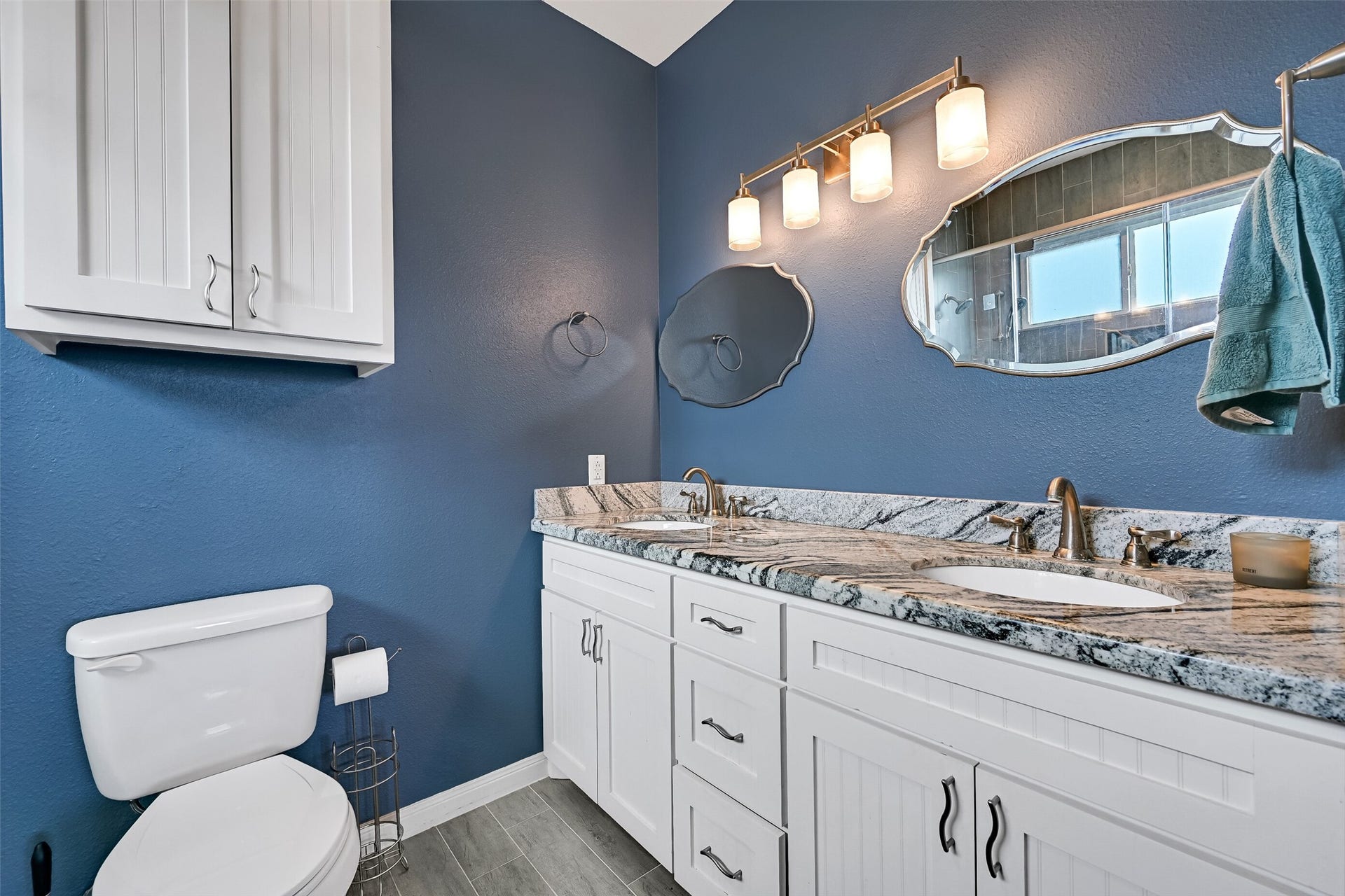 7119 Beau Rue Street, Hitchcock, TX 77563 Primary bathroom featuring double sinks and the same luxurious granite surfaces found in the kitchen.