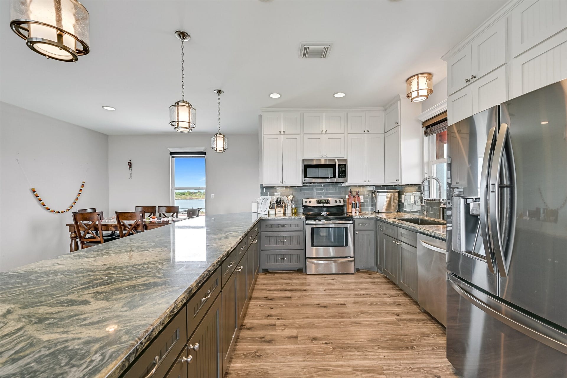 7119 Beau Rue Street, Hitchcock, TX 77563 Once again, storage is the theme of this home! ROWS upon ROWS of custom cabinetry greet you.