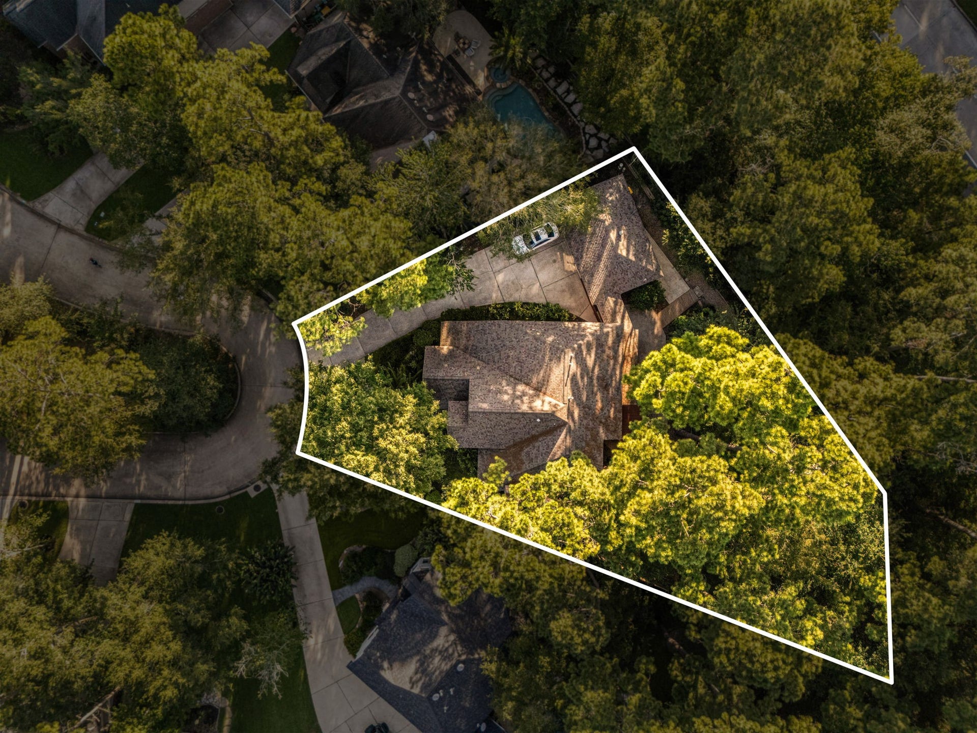 205 Purple Slate Place, The Woodlands, TX 77381 An aerial view showcases the exceptional placement of 205 Purple Slate, nestled deep within a quiet cul-de-sac and wrapped in a dense canopy of mature trees. This premier lot location delivers an incredible sense of privacy and seclusion, shielding the property from neighboring views while keeping you fully immersed in the natural, park-like beauty that makes The Woodlands so highly sought after.