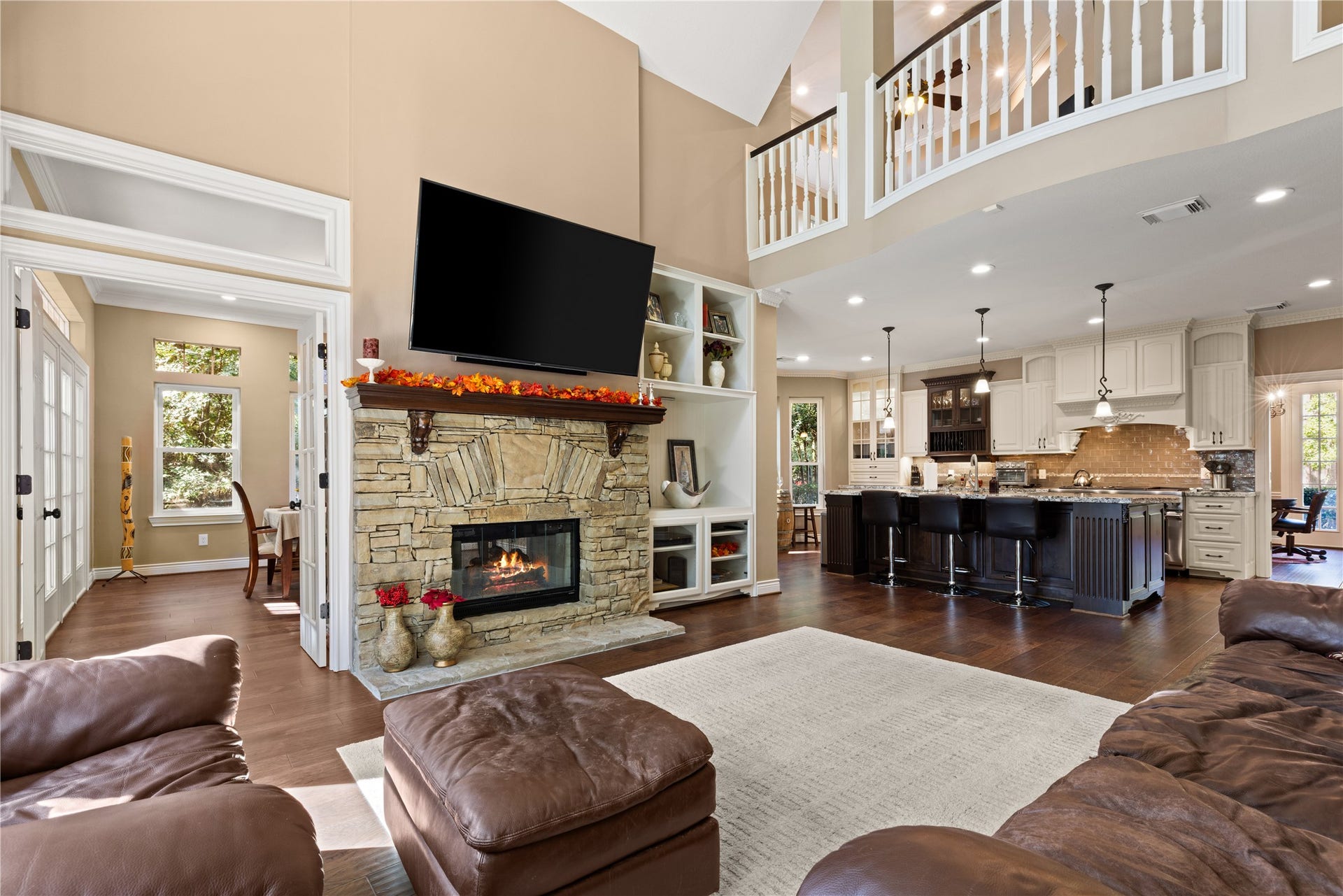 2214 Kings Trail, Kingwood, TX 77339 Open to kitchen. TV included. Fireplace fire has been digitally added for illustrative purposes.