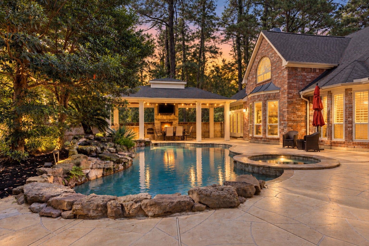 2214 Kings Trail, Kingwood, TX 77339 Resort style backyard with pool, spa, outdoor kitchen and fireplace