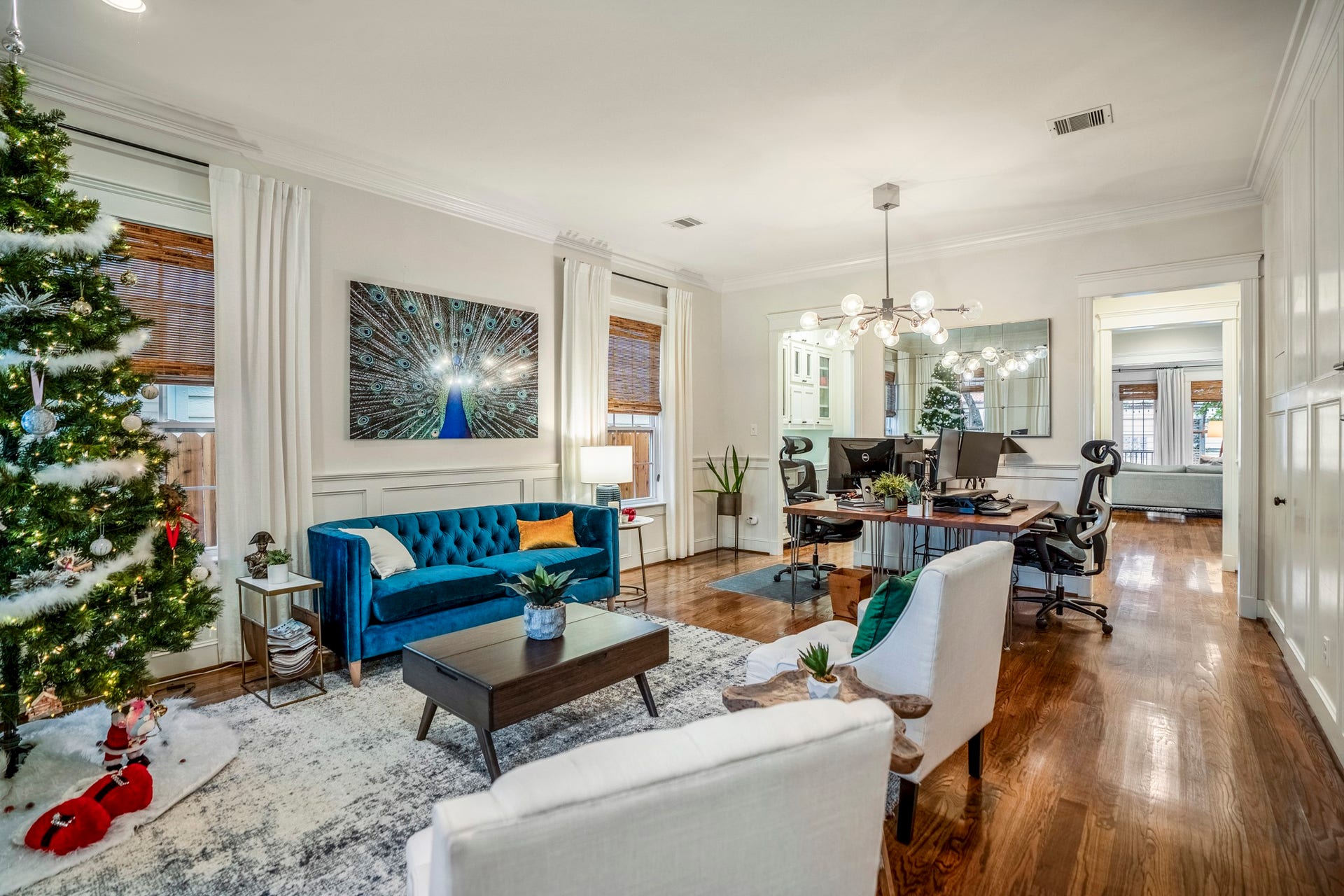 840 Tulane Street, Houston, TX 77007 This spacious living room seamlessly flows into the dining space; seen here as home office. Upgraded woodwork on the walls help elevate this luxurious home. The white wood panels to the right of this picture includes a door that opens up to a closet/storage under the stairs.