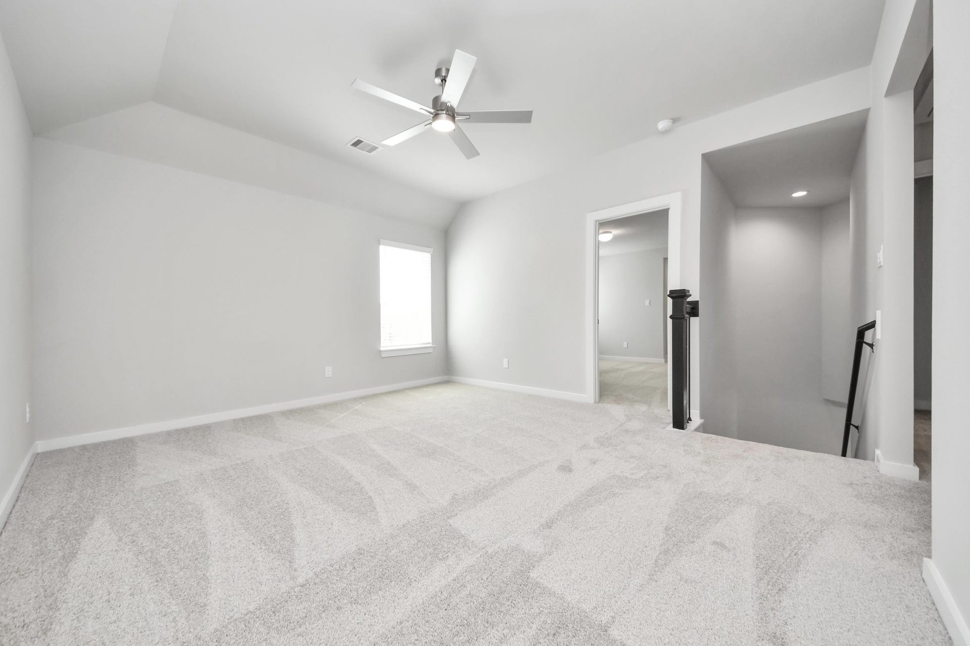 Ascend to relaxation in this fantastic game room! Ideal for both casual gatherings and adult gaming, it boasts plush carpet, lofty ceilings, custom paint, and ample windows for abundant natural light. Sample photo of completed home with similar floor plan. Actual colors and selections may vary.