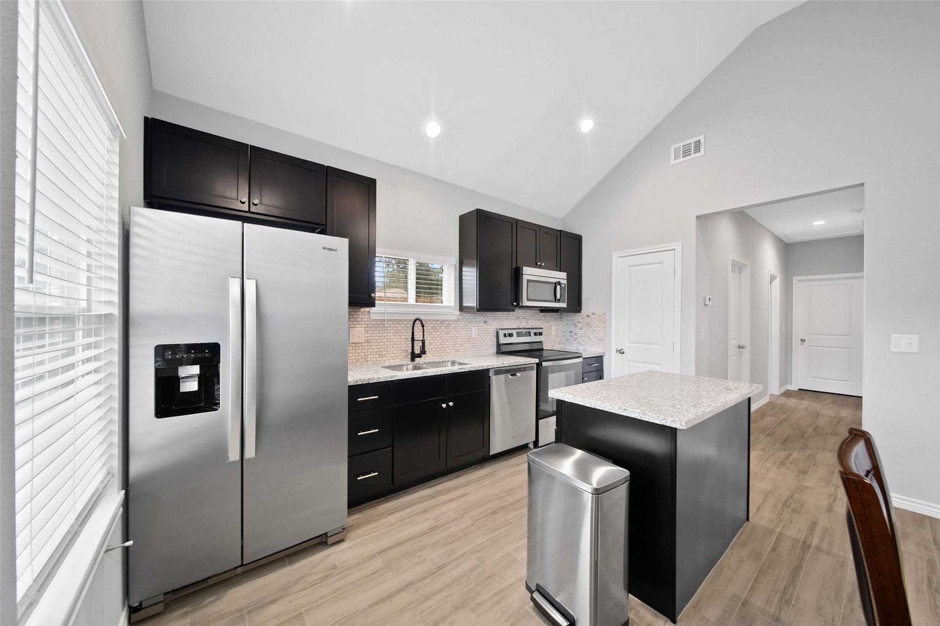 801 Omeara, Montgomery, TX 77316 Open kitchen featuring granite countertops and matching stainless steel appliances, including the refrigerator.