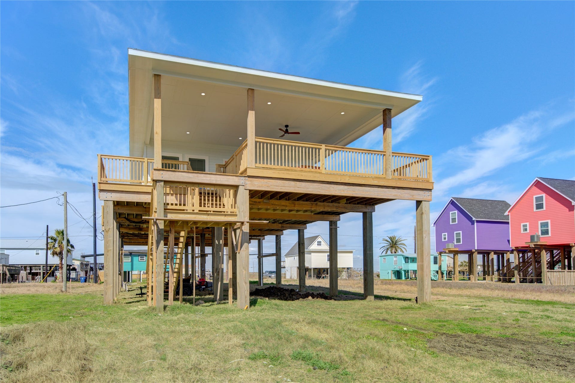 1014 Treaty Dr, Surfside Beach, TX 77541 Full exterior view showcasing elevated construction and open surroundings