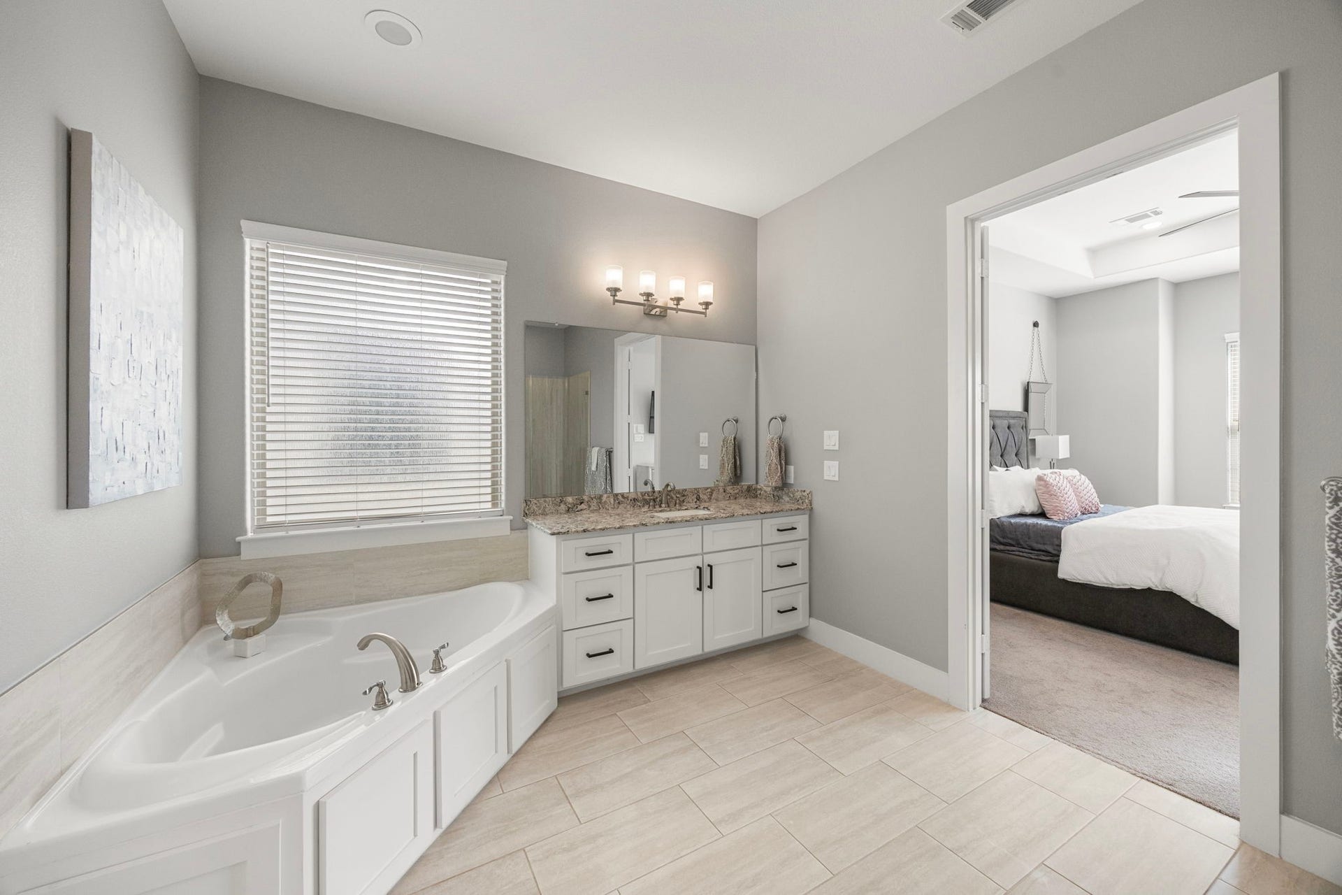 1216 Murrayhill Drive, Houston, TX 77043 Indulge in the primary bath featuring a dual-sink vanity, soaking tub, and separate shower.