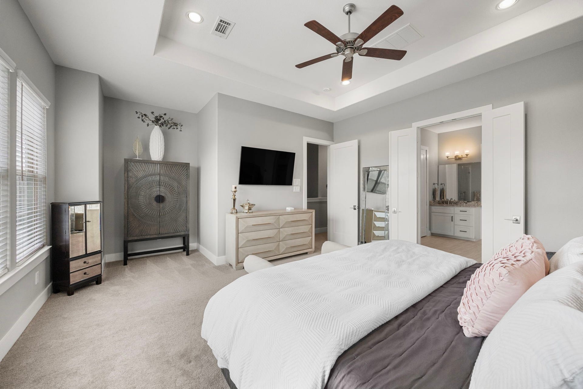 1216 Murrayhill Drive, Houston, TX 77043 Spacious primary bedroom featuring elegant tray ceilings, abundant natural light, and direct access to a luxurious ensuite bathroom.