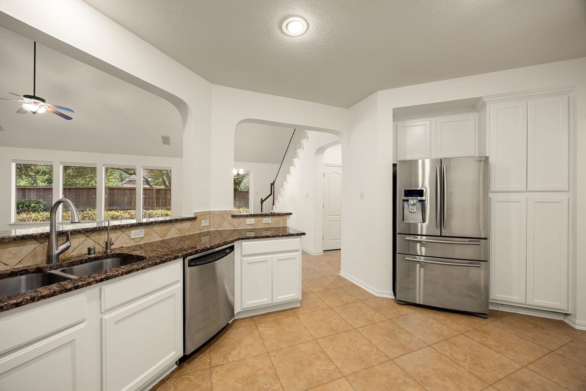 9430 Amethyst Arbor Lane, Katy, TX 77494 Premium stainless steel appliances take center stage in this final kitchen angle, seamlessly blending modern efficiency with the home's bright, open aesthetic.