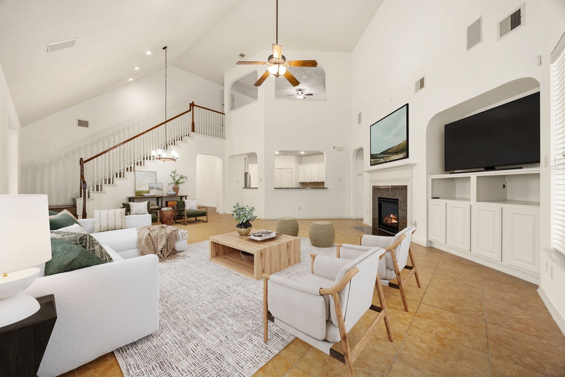 9430 Amethyst Arbor Lane, Katy, TX 77494 This alternate view of the expansive family room reveals the true grandeur of the home's open-concept design, anchored by a soaring two-story ceiling and a sweeping staircase. *Virtually Staged