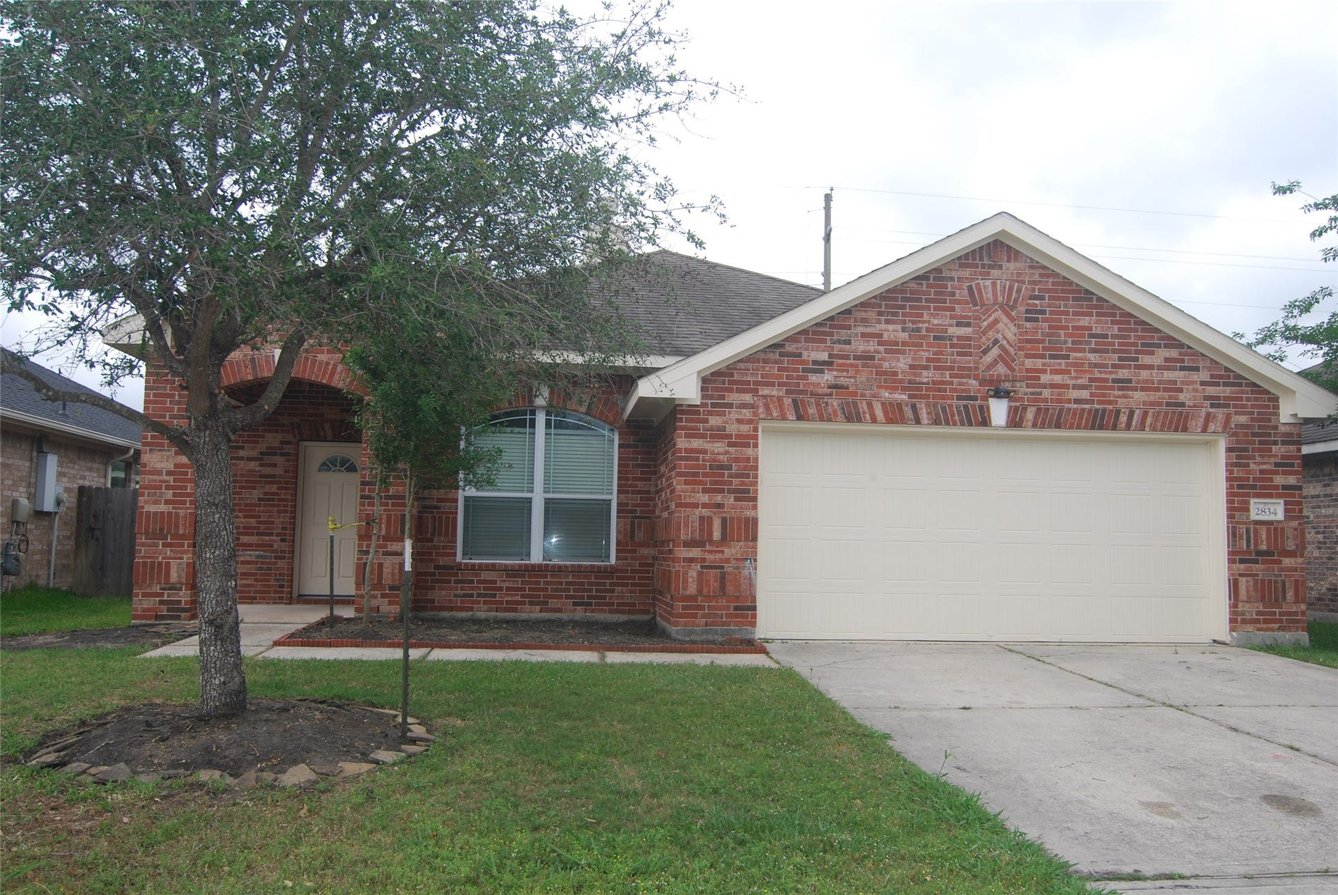 Charming single-story brick home with a cozy front porch and a well-maintained lawn. Features a two-car garage and NEW ROOF!